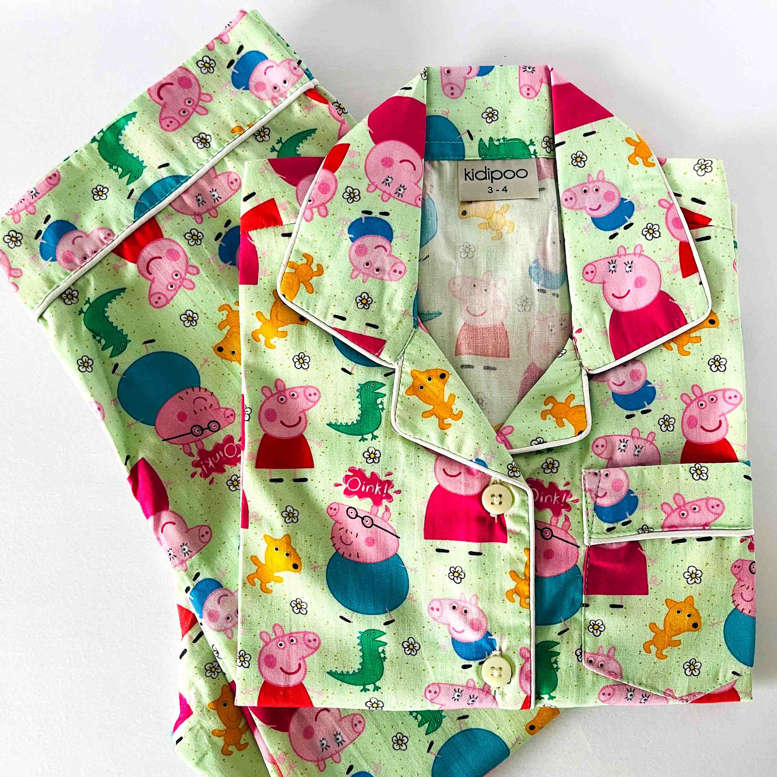 Green Peppa pig cartoon print kids night suit soft cotton sleepwear set folded view