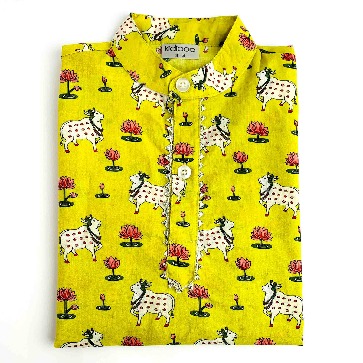 Folded yellow-green children’s kurta with an all-over cow and lotus print, featuring a Mandarin collar, buttoned front placket with decorative trim, and long sleeves, displayed on a white background.