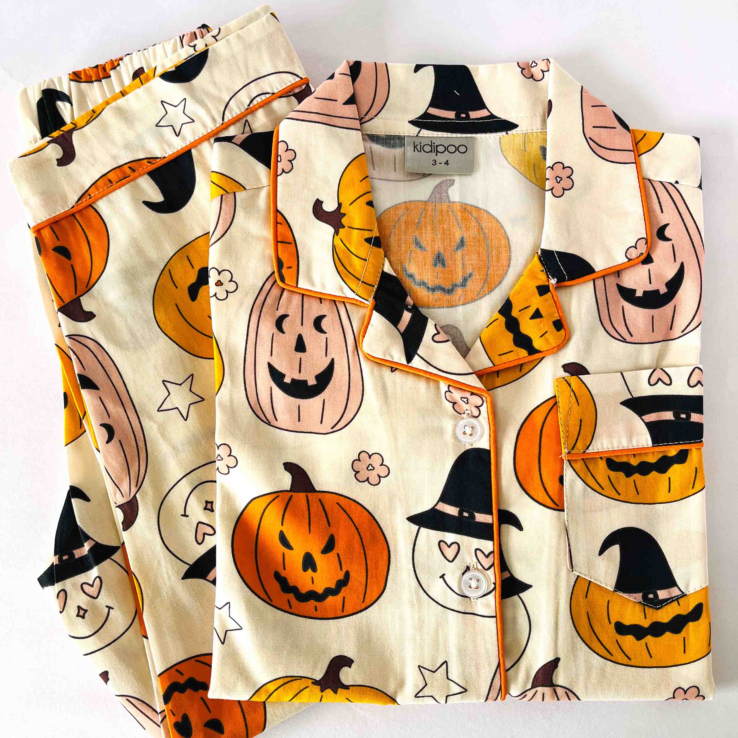 Kids Halloween pumpkin print night suit soft cotton festive sleepwear set beige base folded view