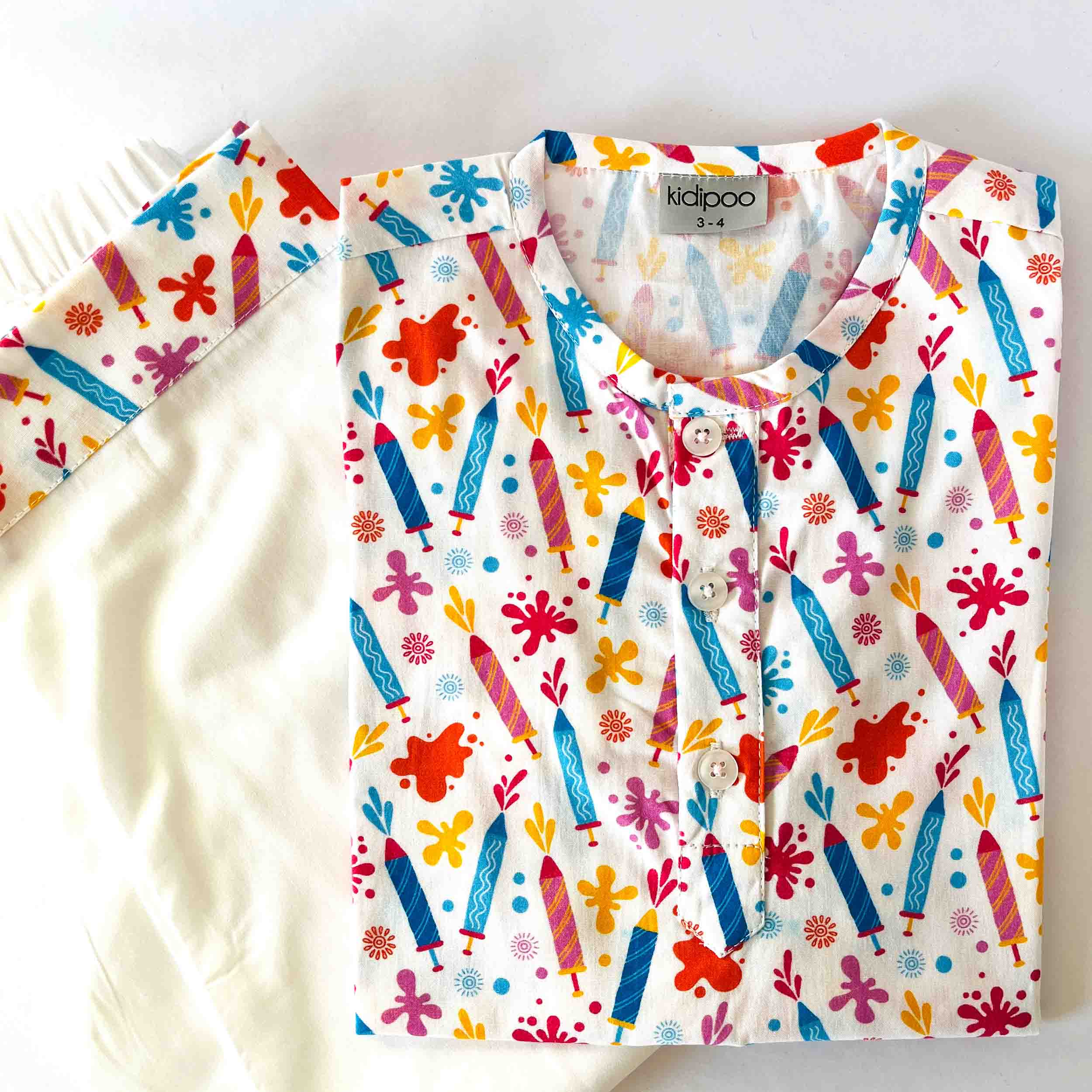 Children's outfit with colorful crayon pattern on a white background