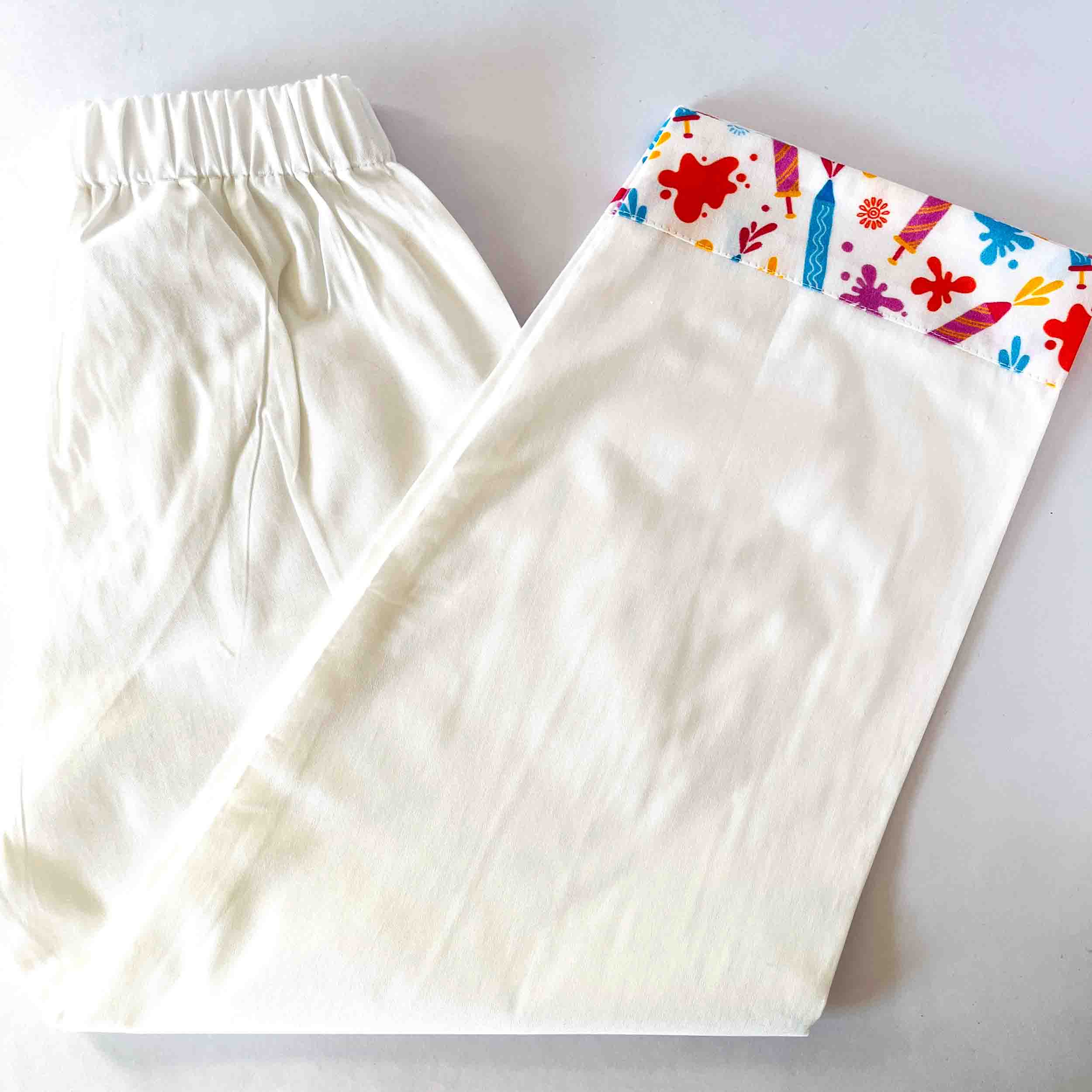 White pants with colorful floral pattern on a white background