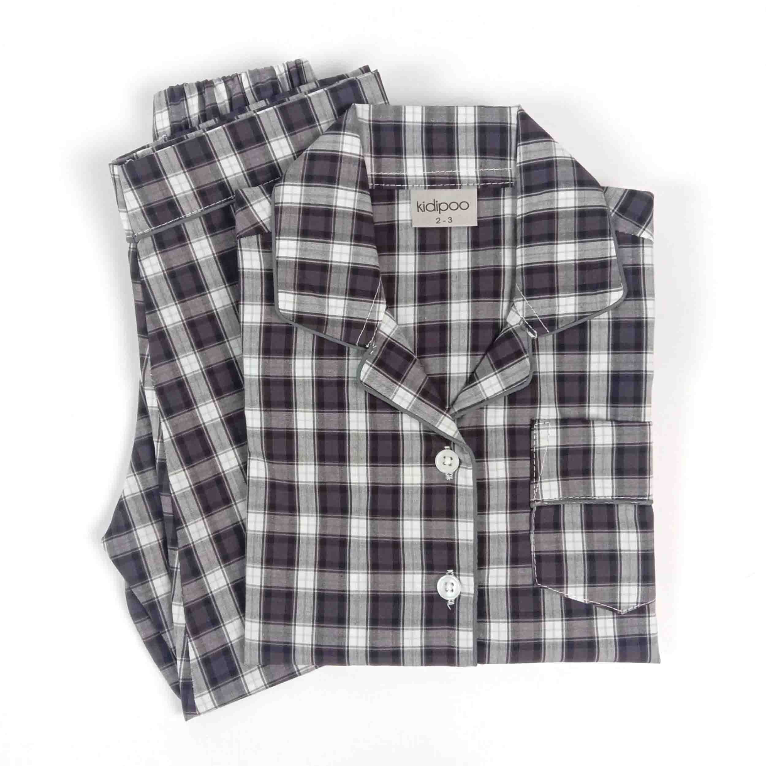 Folded black, gray, and white checkered cotton night suit with a long-sleeve button-up shirt and matching full-length pajama pants, displayed on a white background