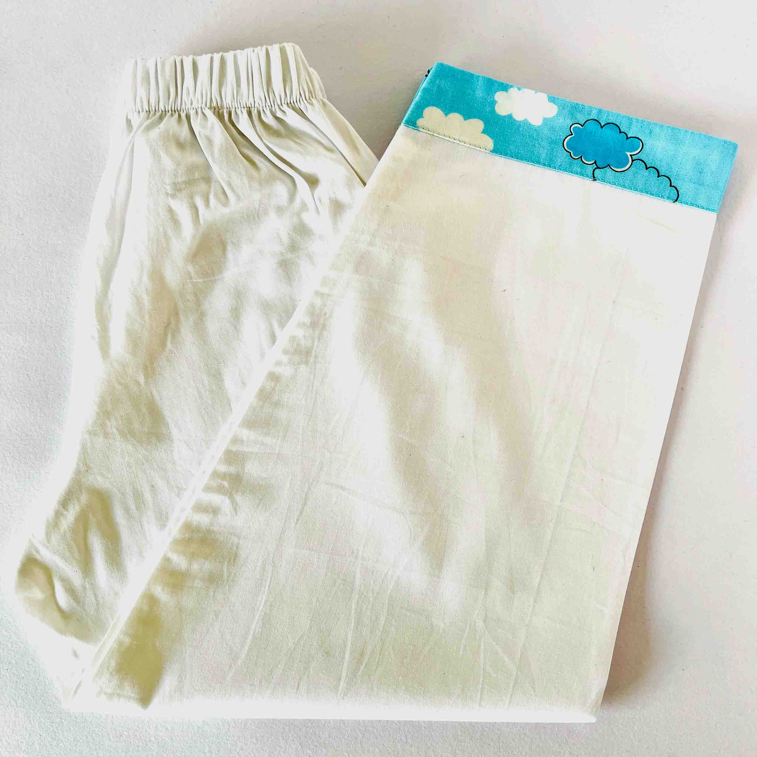 White pants with a cloud design on a white background