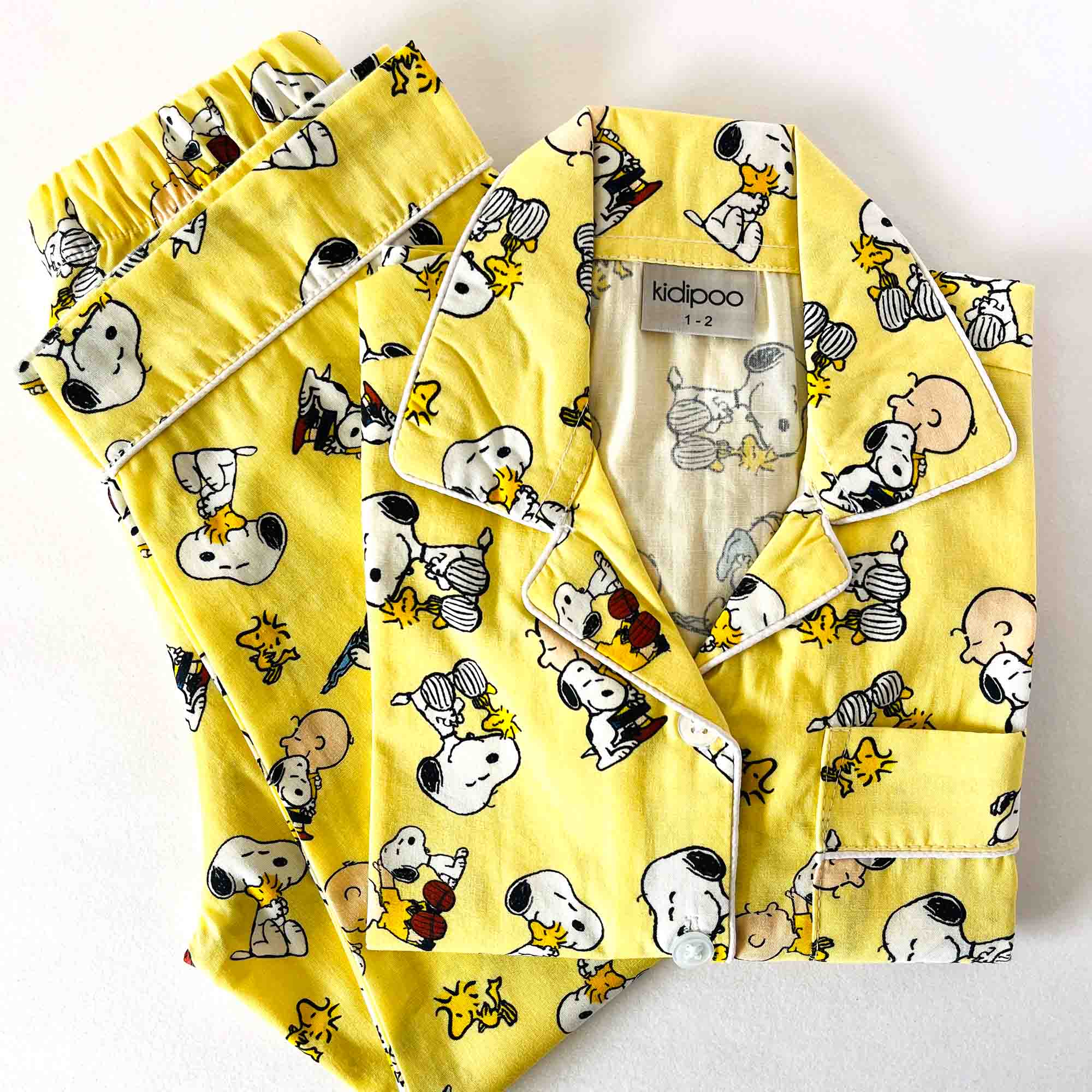 Yellow pajama set with cartoon characters on a white background