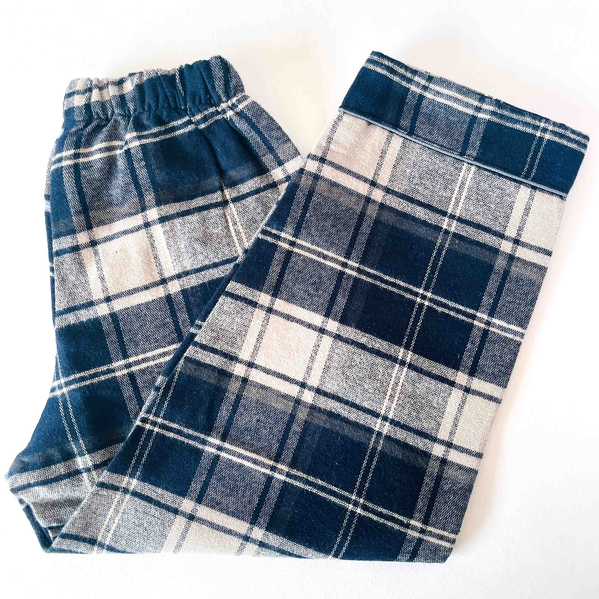 Blue and white plaid flannel pants on a white background