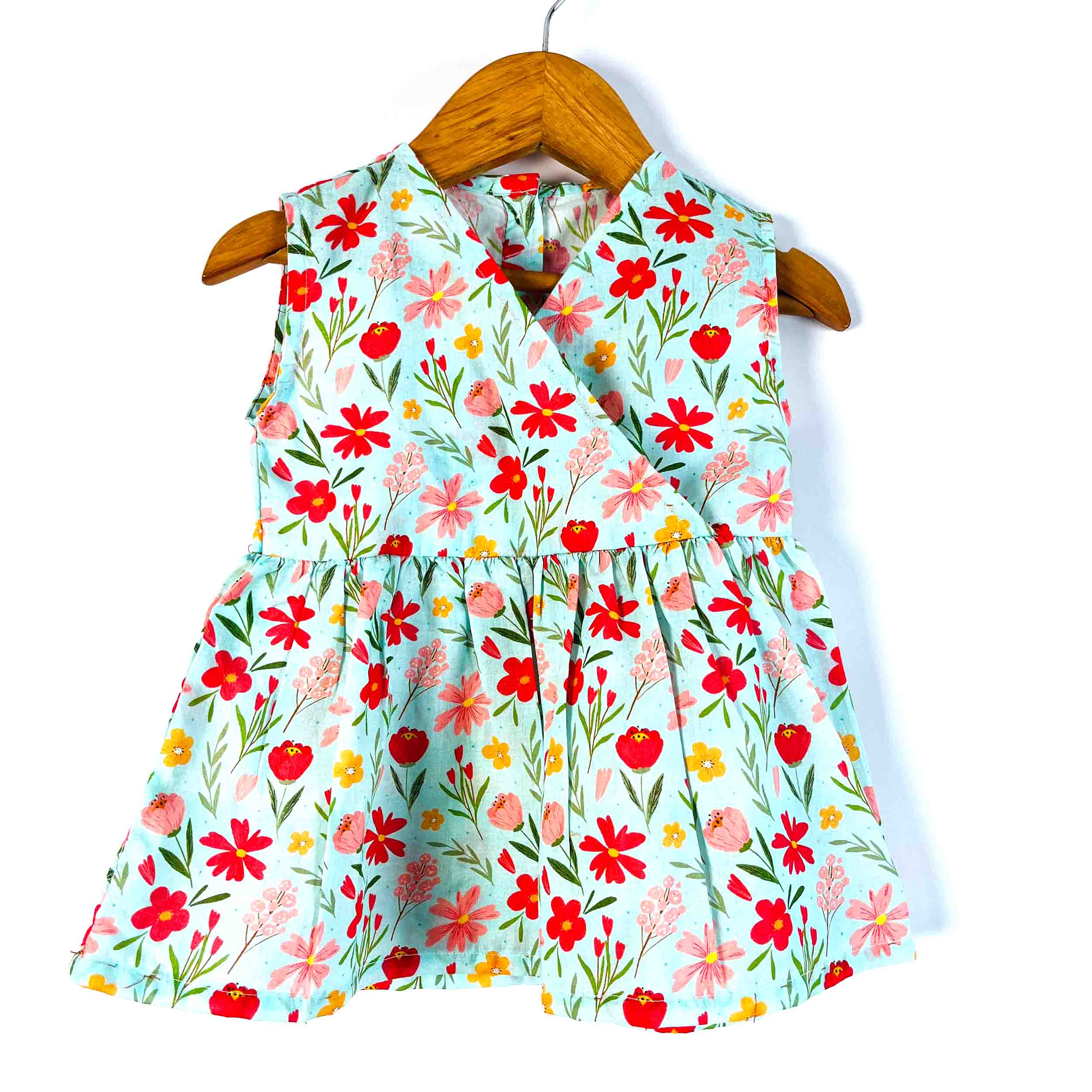 Girls' mint floral sleeveless peplum top front view with a V-neckline and gathered waist, made from 100% premium cotton