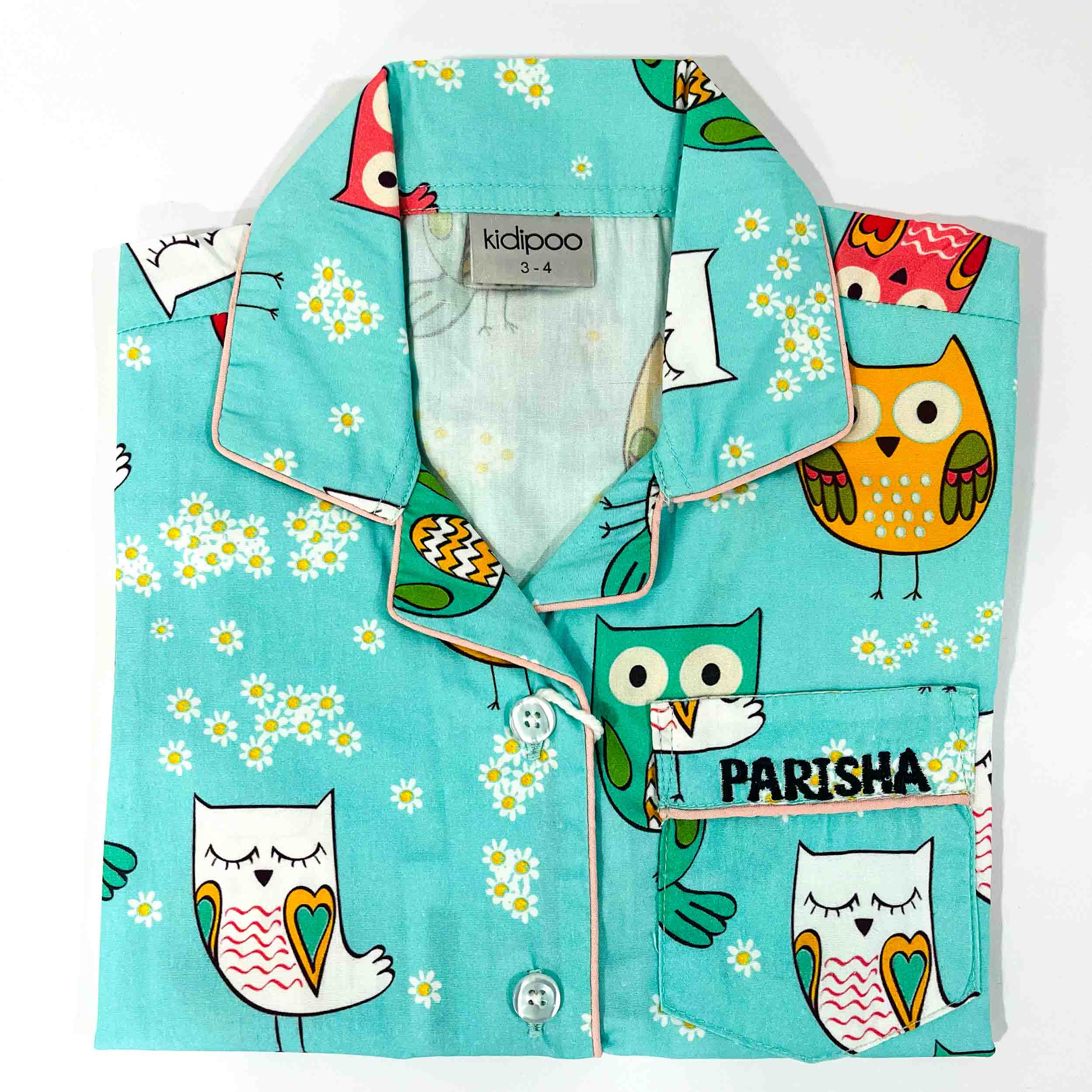 Children's pajama set with owl design on a turquoise background, featuring the brand 'kidpoo'.