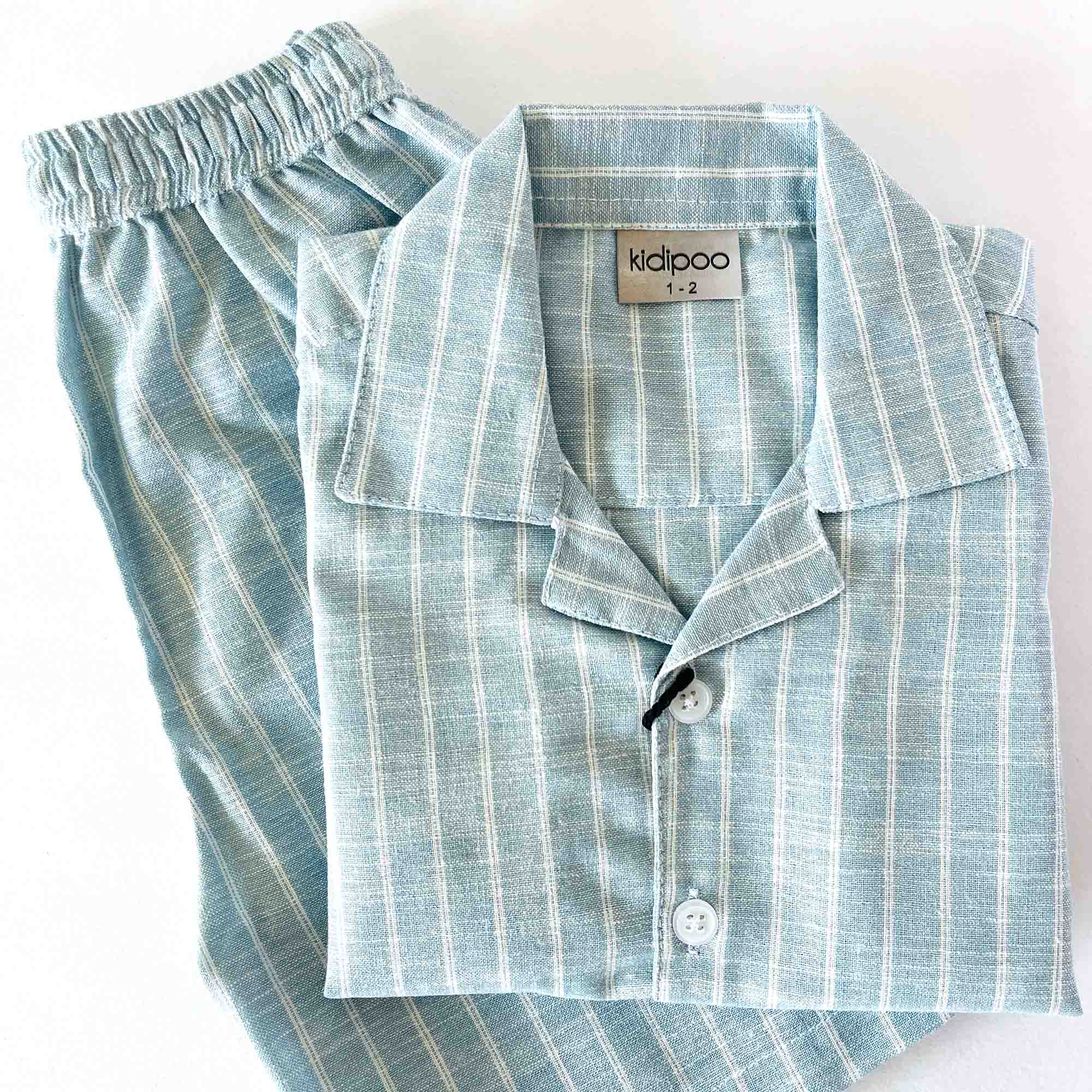Folded blue striped coord set on a white background
