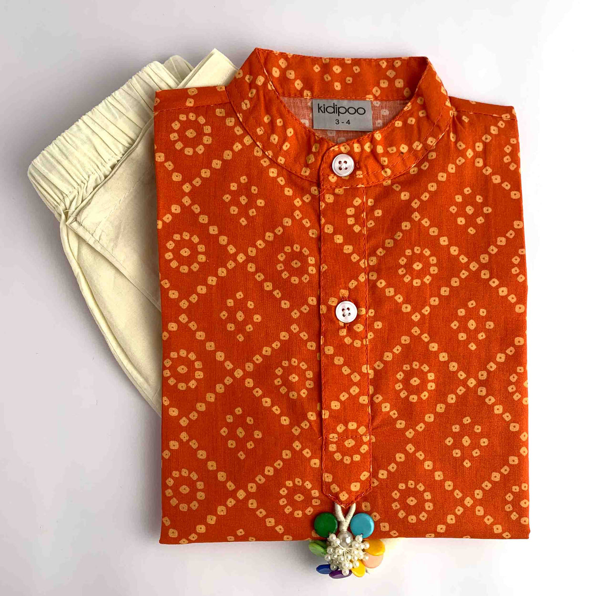 Orange Badhni printed kurta pajama set for kids with cream pajama