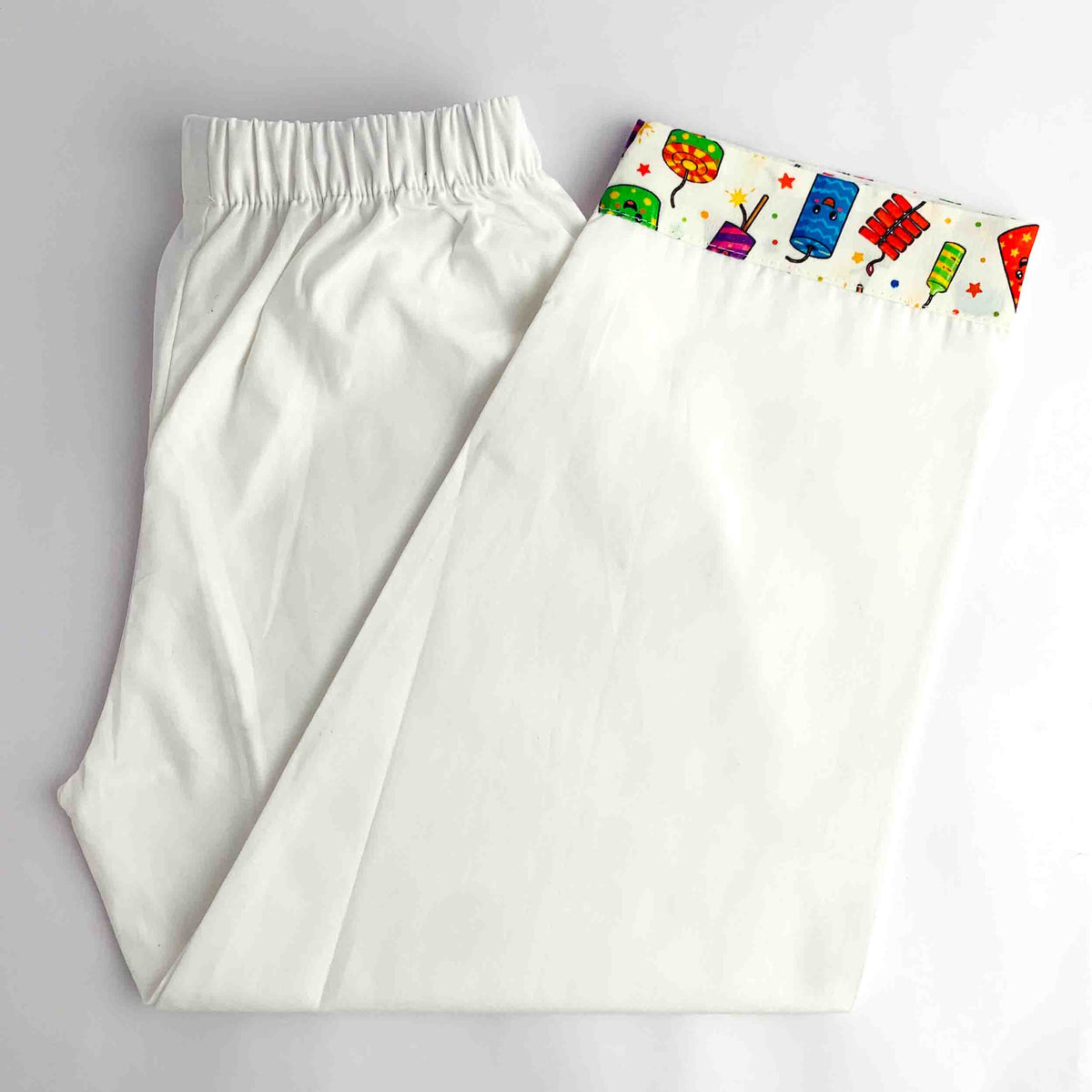 White kids pajama with colorful Cards Carnival printed fabric at the bottom