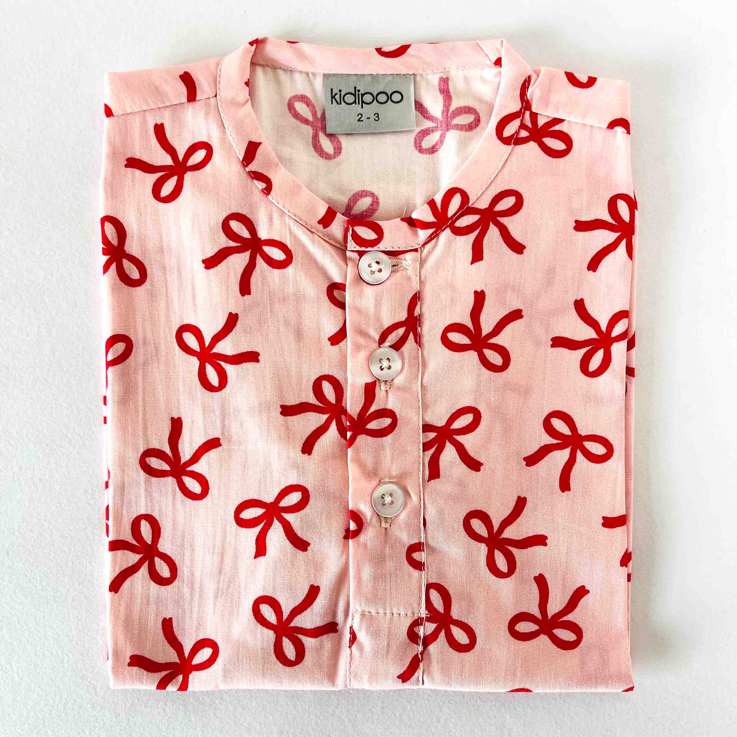Kids cotton night shirt with pink bows print and round neck long sleeve design