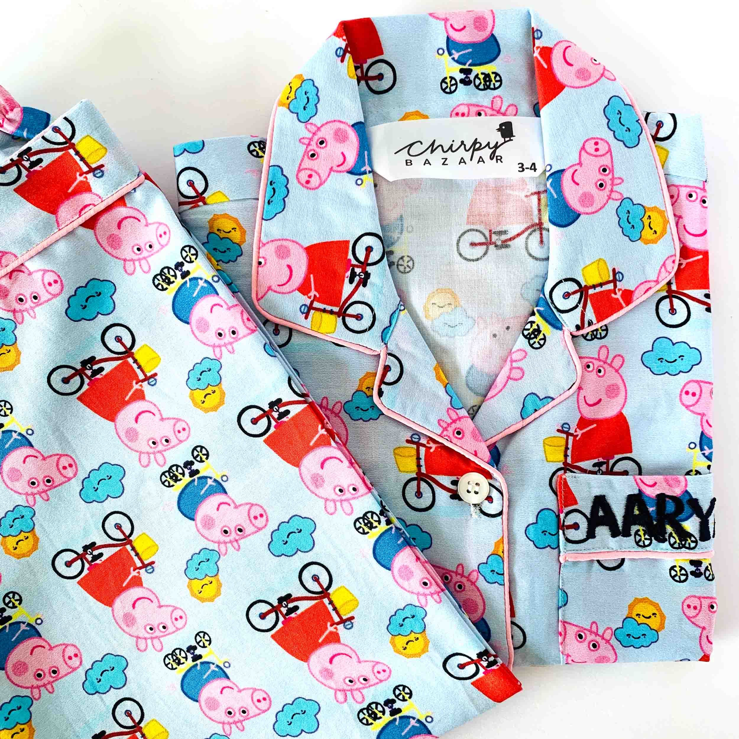 Children's pajama set with Peppa Pig pattern on a light blue background