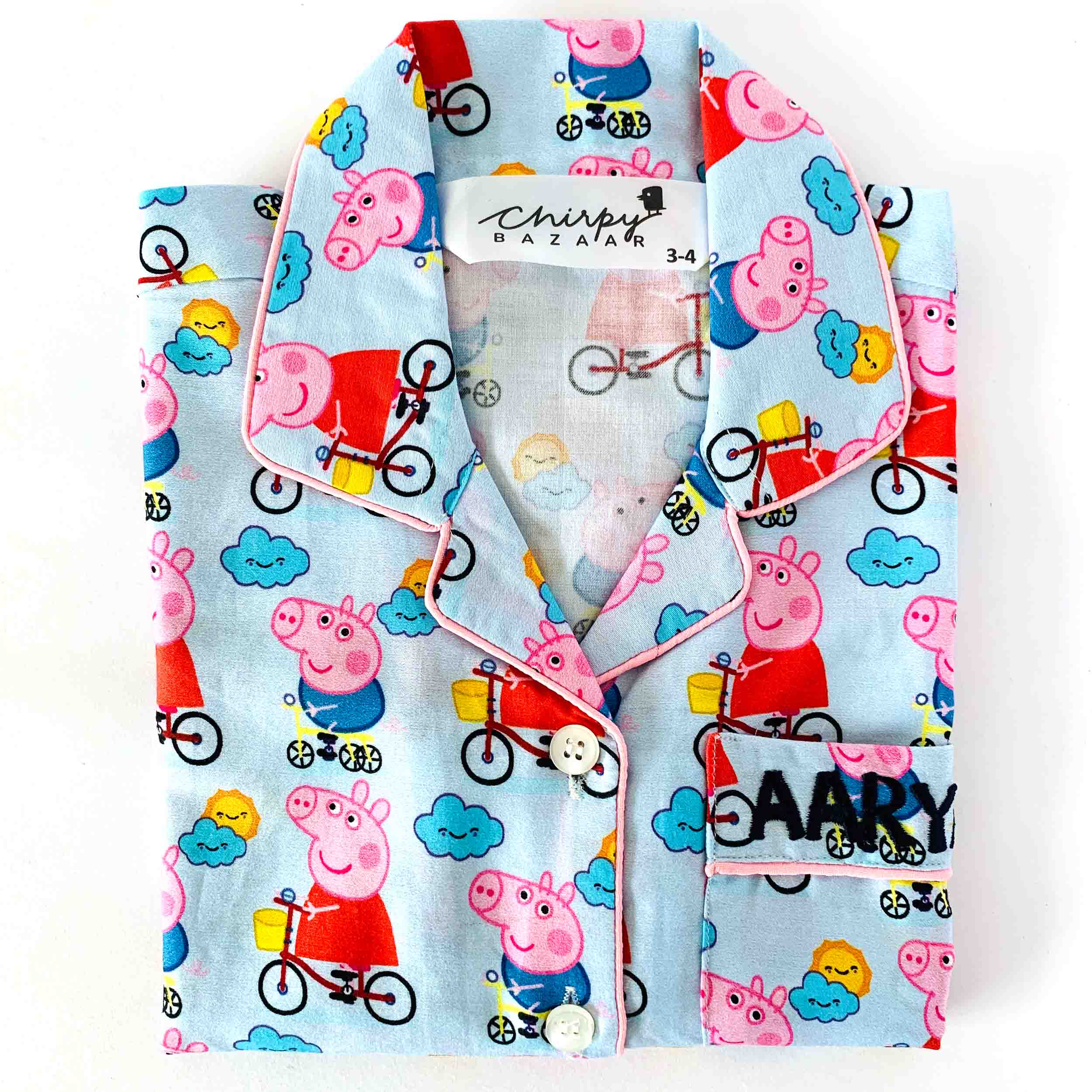 Children's outfit with Peppa Pig pattern on a white background