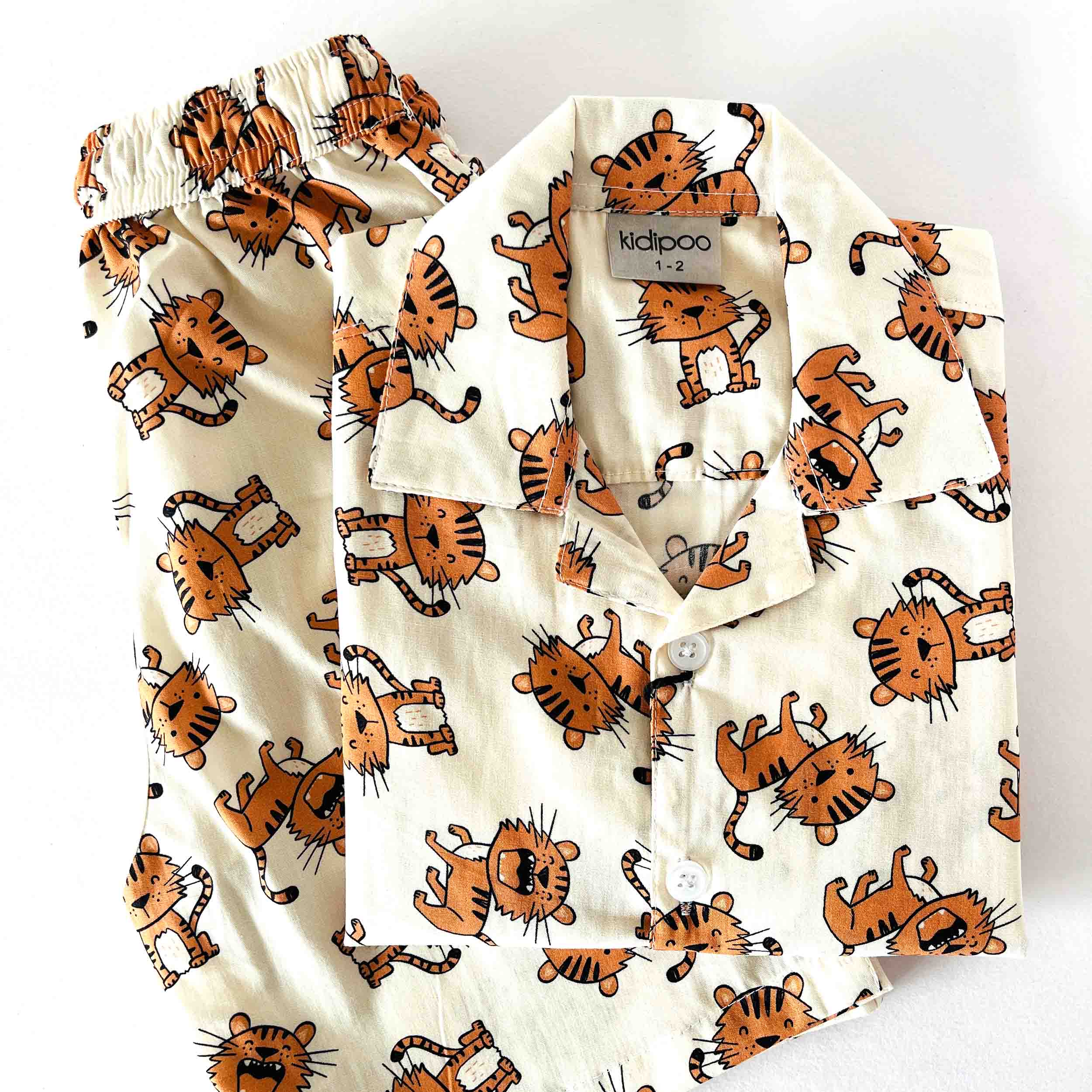 Children's pajama set with tiger pattern on a white background