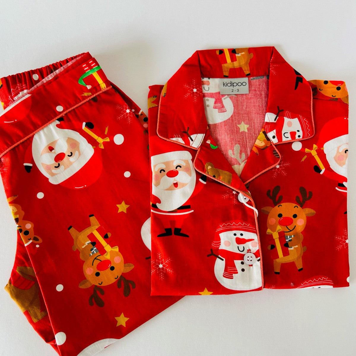 A red Santa Claus night suit with printed Christmas-themed characters, including Santa, reindeer, and snowmen.