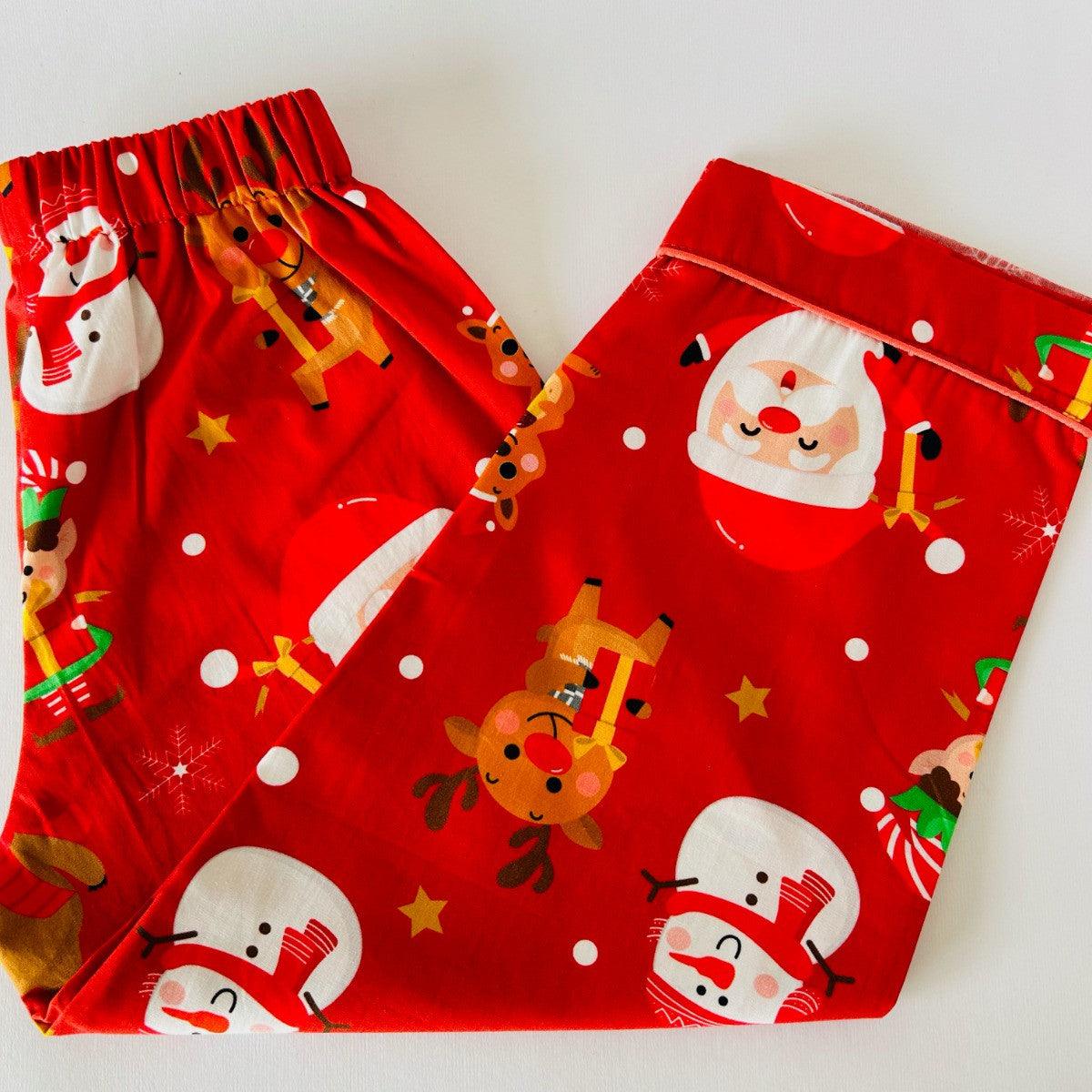 A red Santa Claus night suit with printed Christmas-themed characters, including Santa, reindeer, and snowmen.