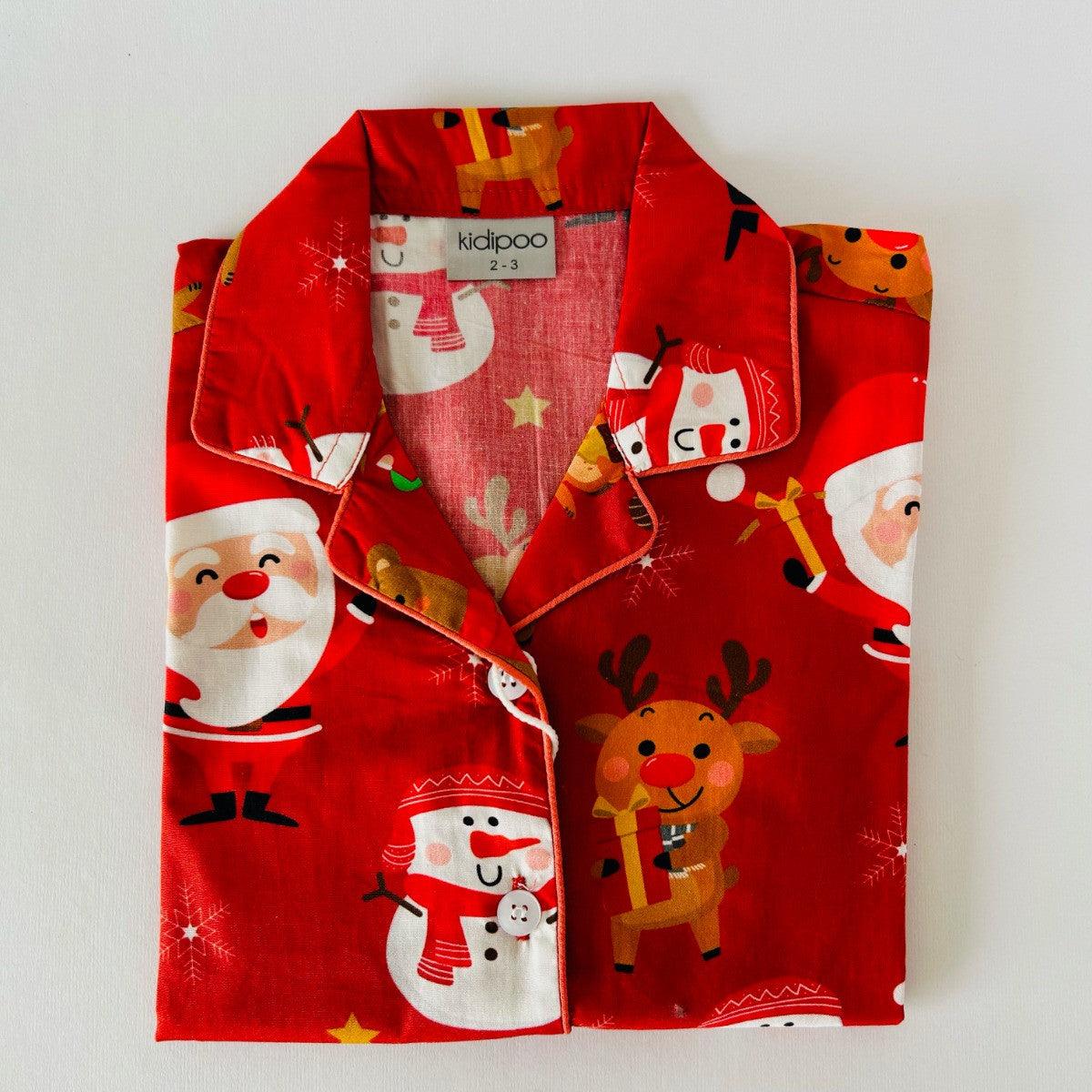 A red Santa Claus night suit with printed Christmas-themed characters, including Santa, reindeer, and snowmen.