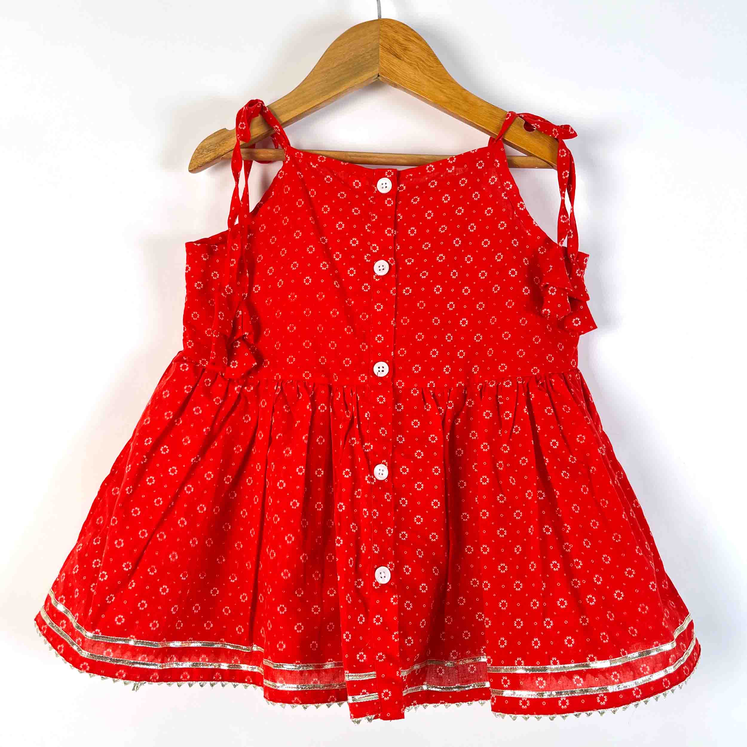 Back view of Girls Red Utsav Sharara Set showing tie-up shoulder straps, button-back design and flared cotton kurti