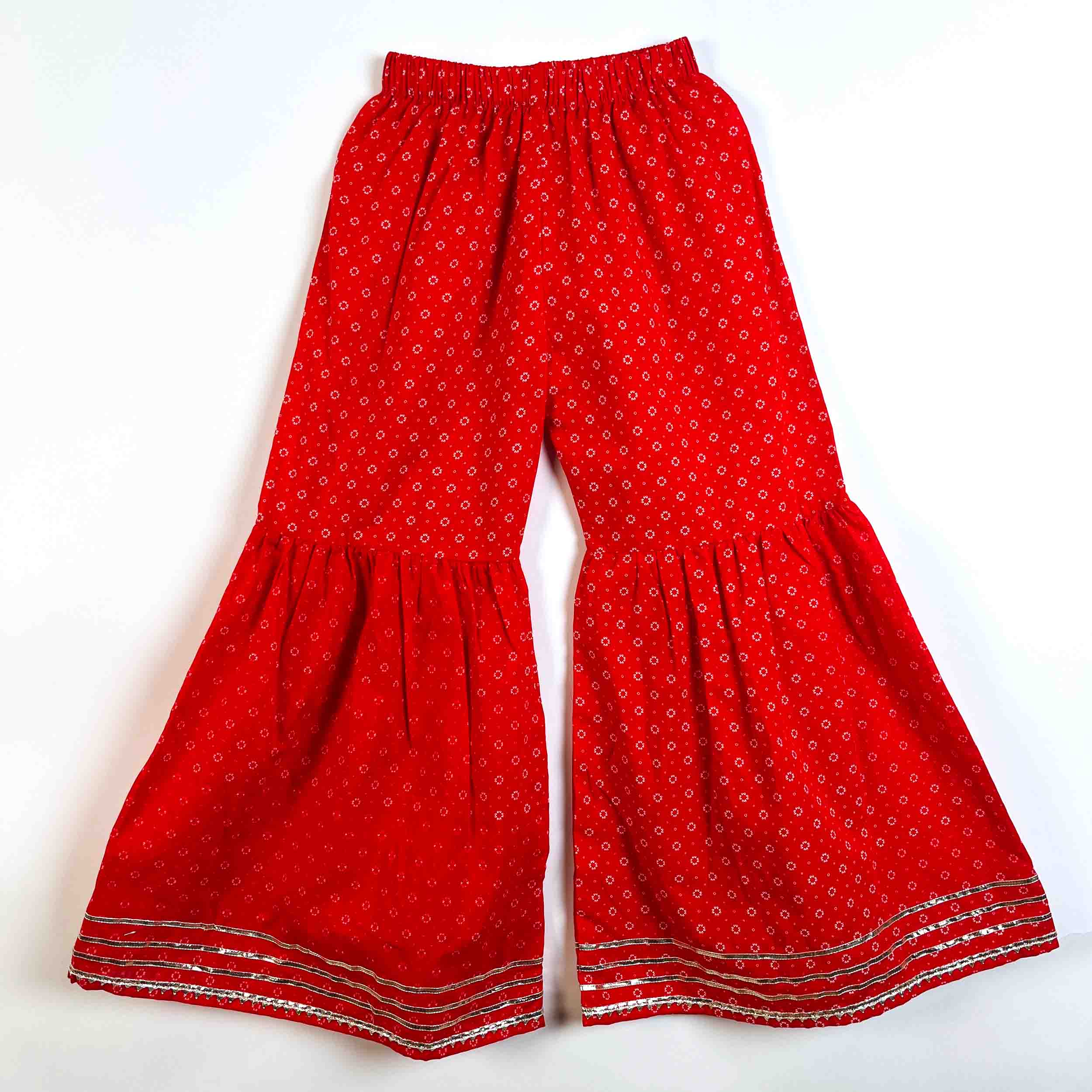 Red wide-leg pants with a small white geometric pattern and silver metallic embroidered borders at the bottom, displayed flat against a white background.