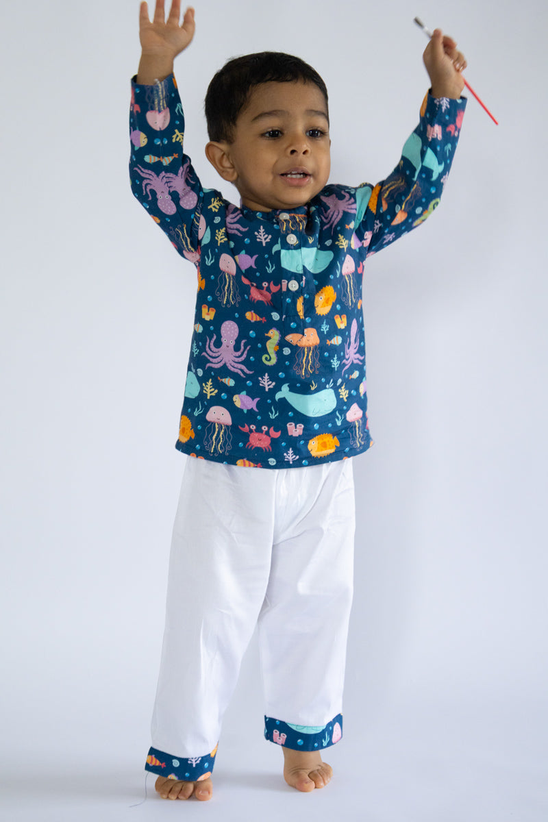 "Kid wearing Kidipoo sea creatures print cotton kurta pajama set playful pose kids outfit"