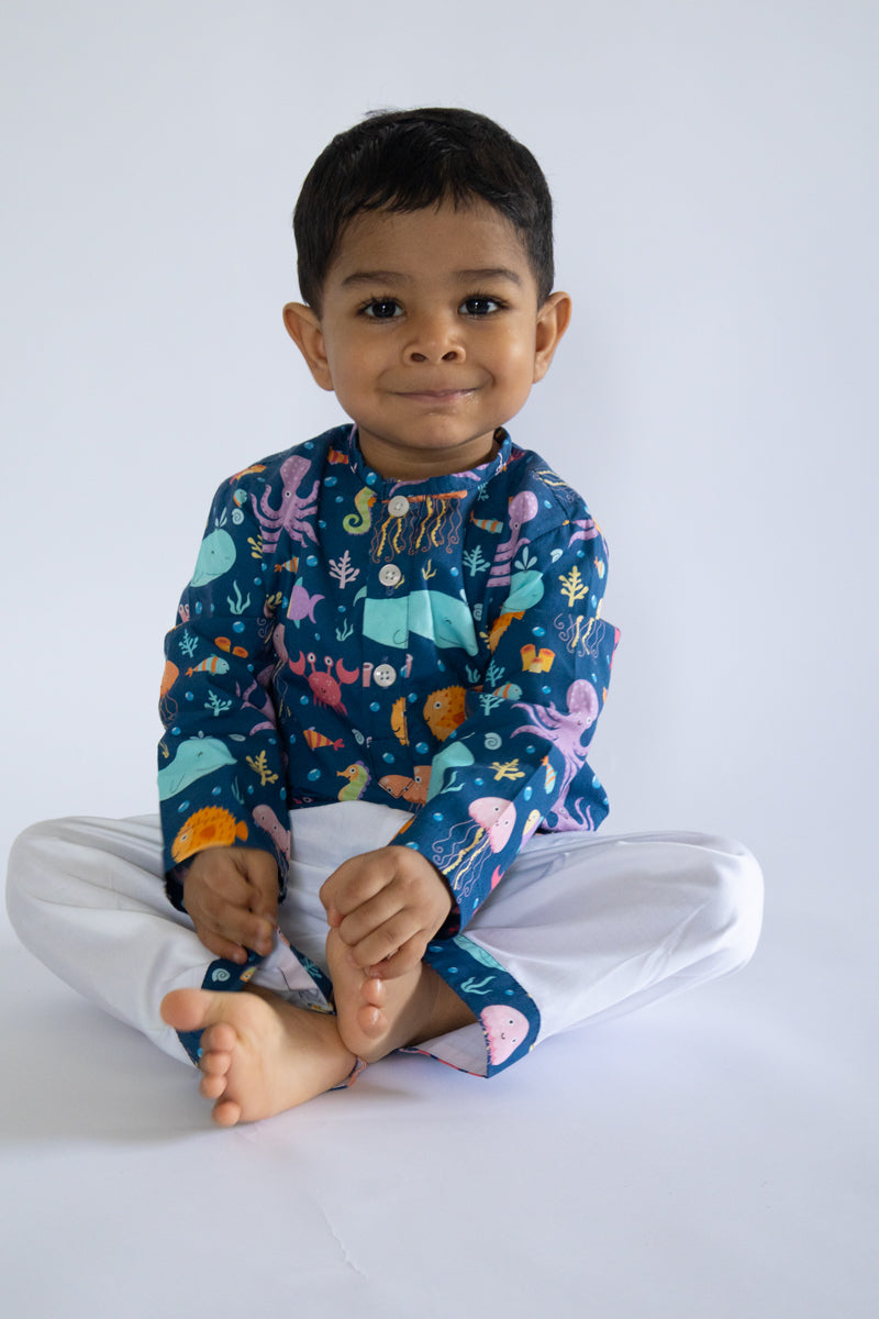 "Kid wearing Kidipoo sea creatures print cotton kurta pajama set sitting pose kids ethnic wear"
