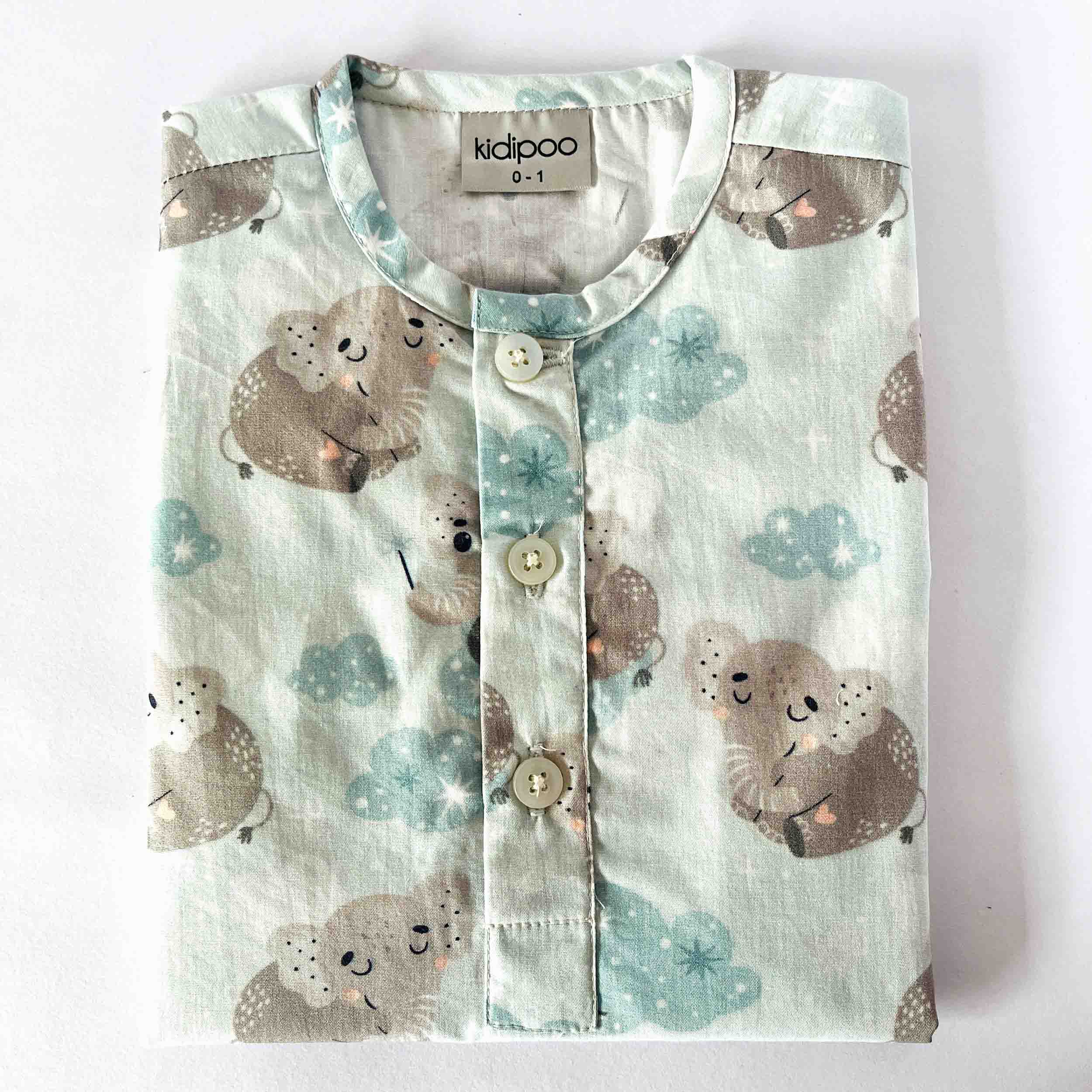 Children's shirt with koala pattern and 'kidipoo' branding on a white background