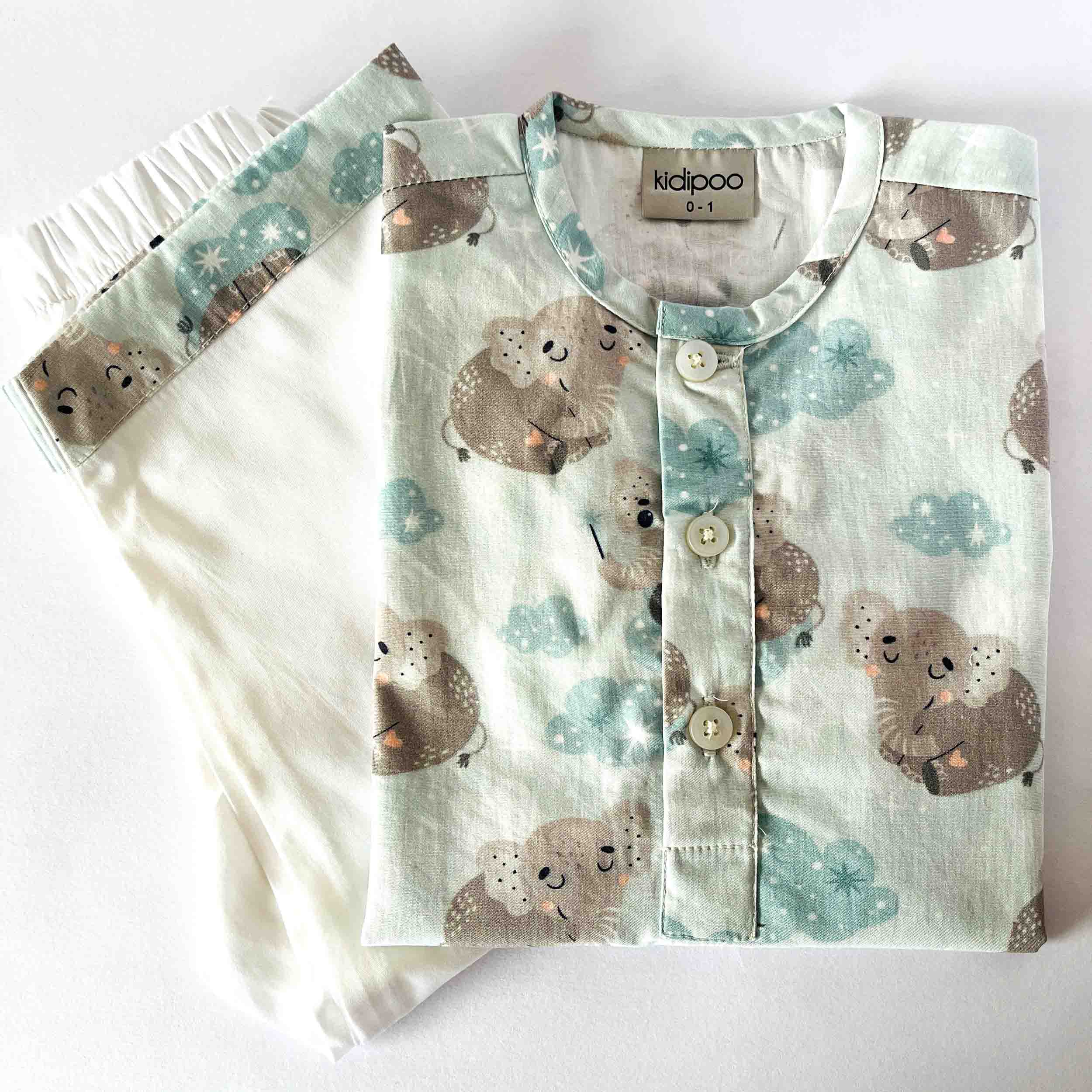 Children's pajama set with bear pattern on a white background