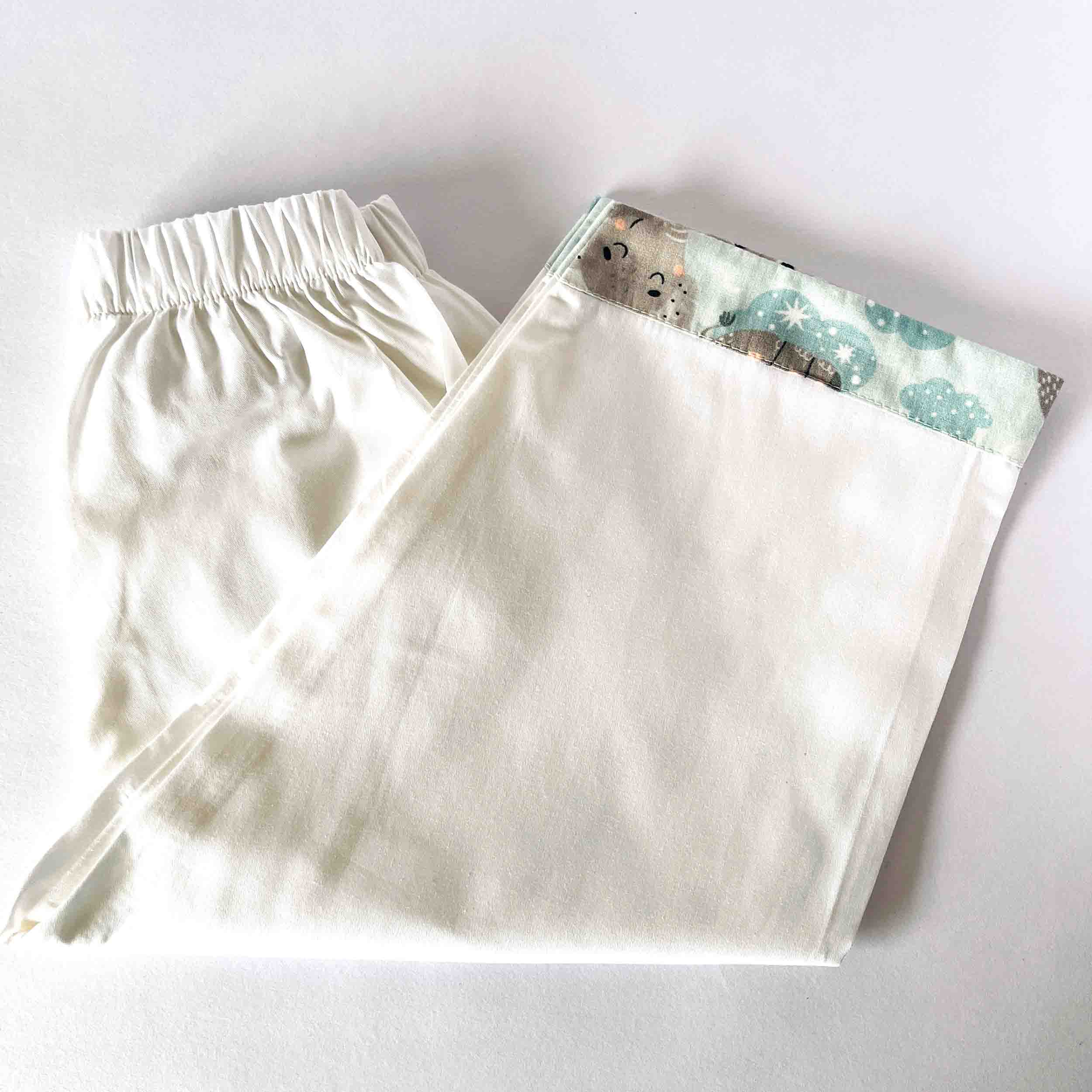 White shorts with a patterned pocket on a white background