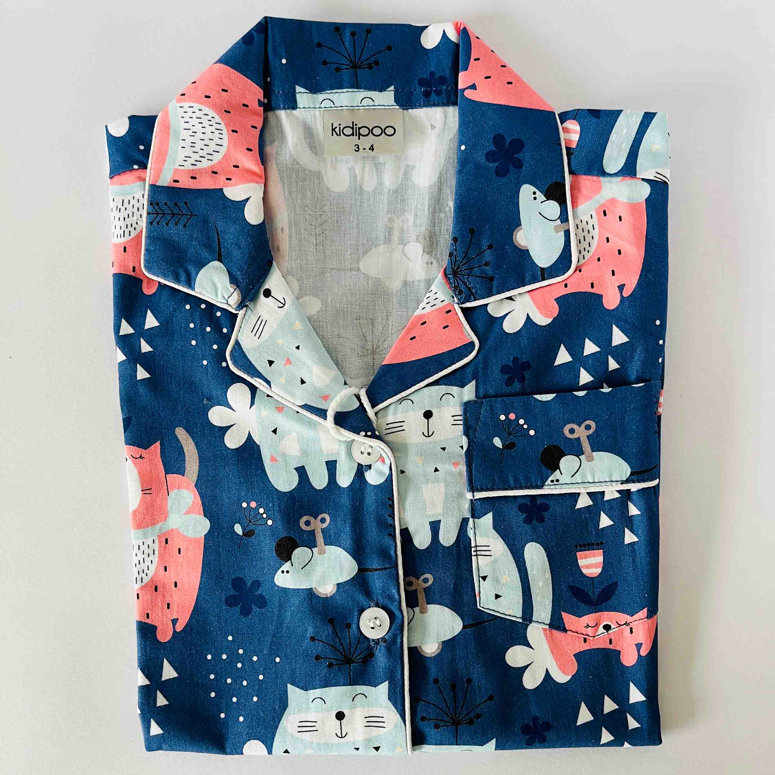 Children's pajama set with animal pattern on a light gray background