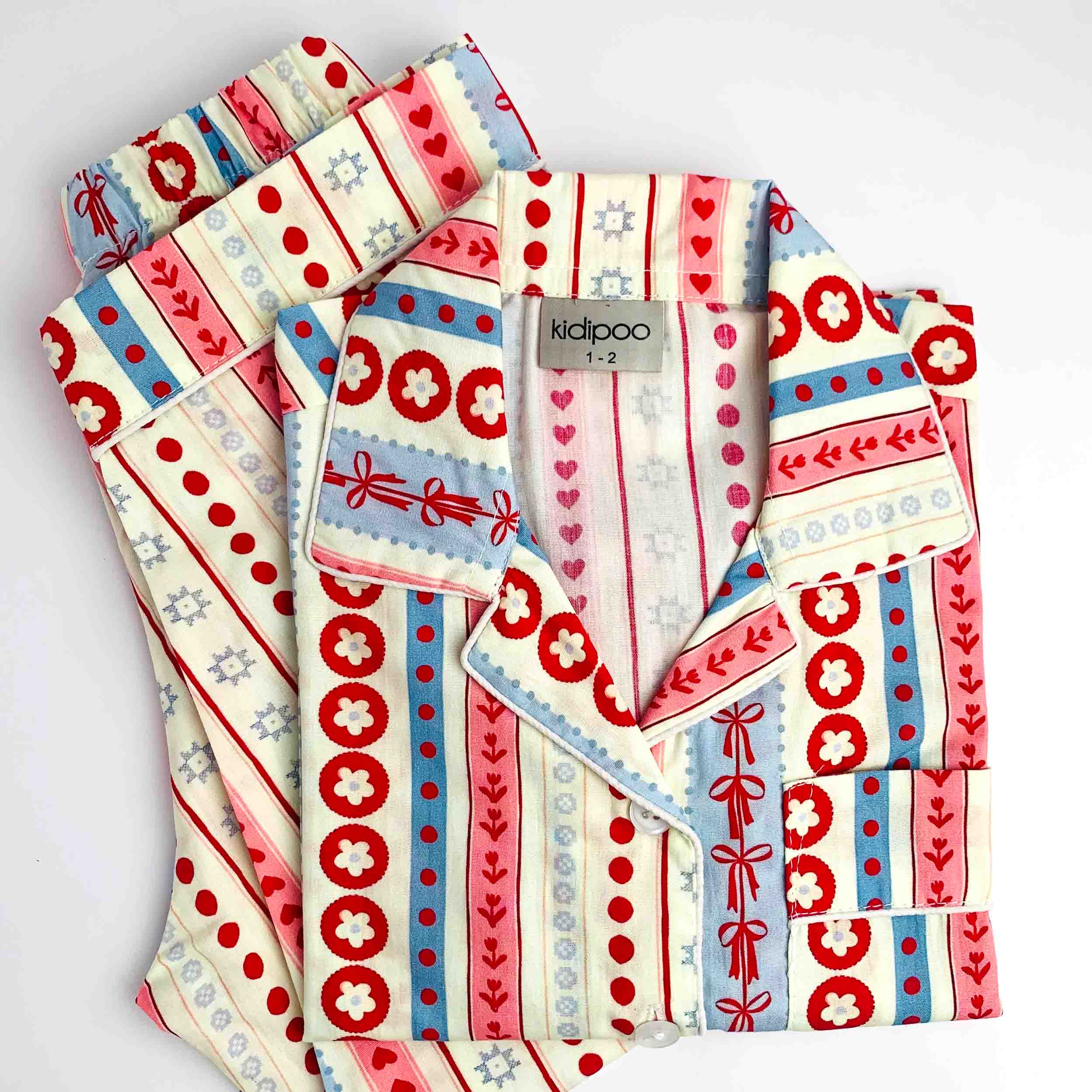Kids printed shirt and pant night suit set with red, blue, and cream stripes, dots, and heart pattern made from soft cotton
