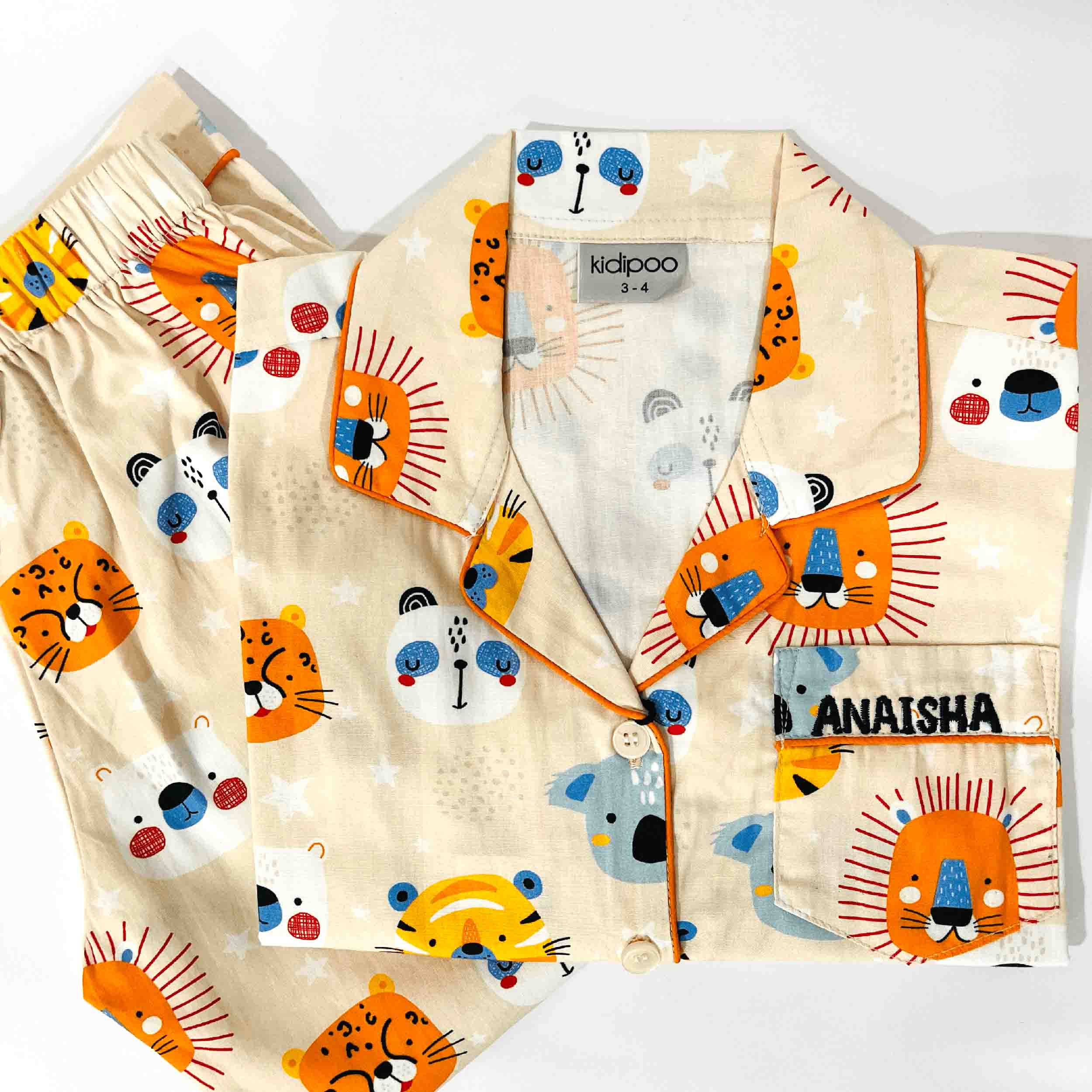Children's pajama set with lion pattern on a white background