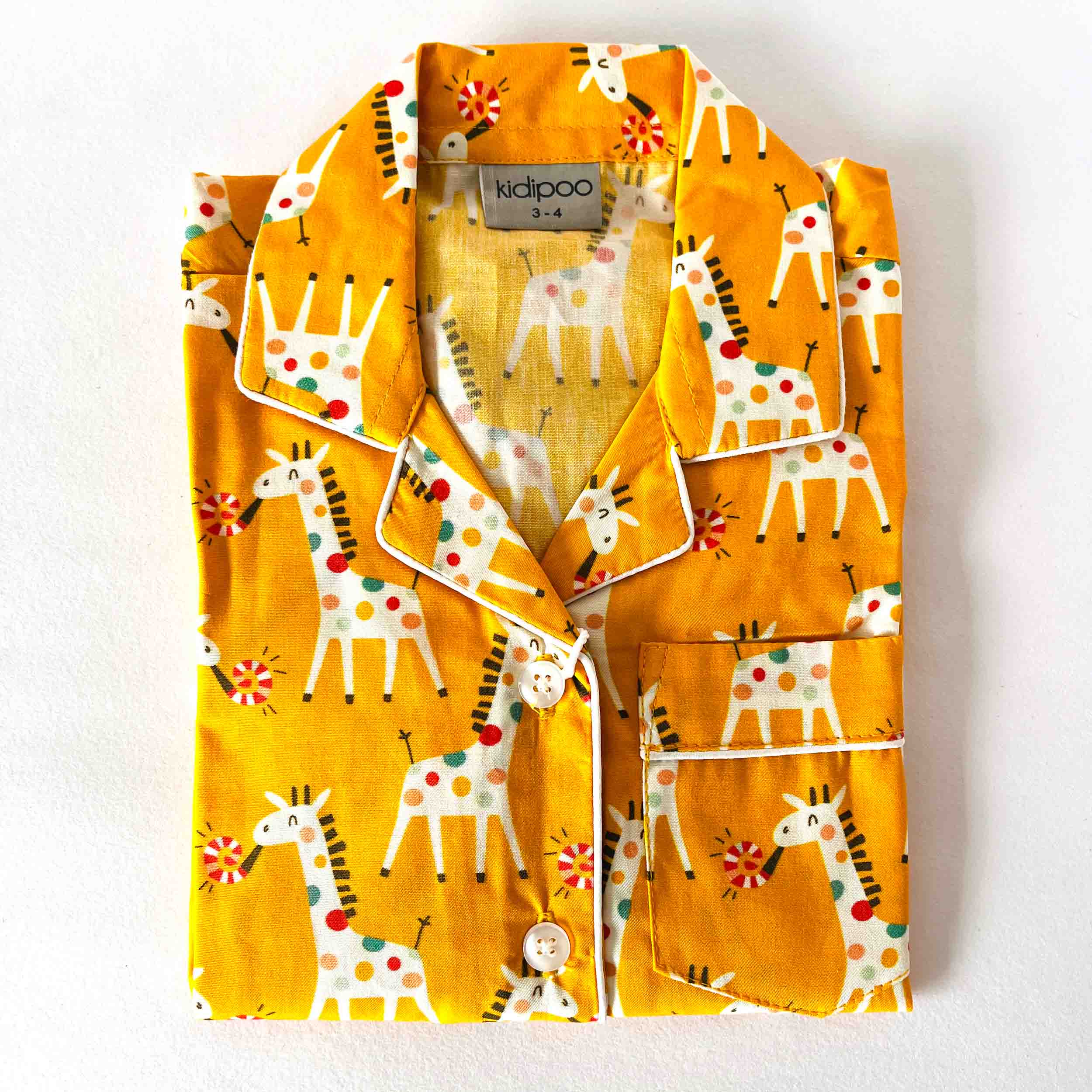 Children's pajama set with giraffe pattern on a white background