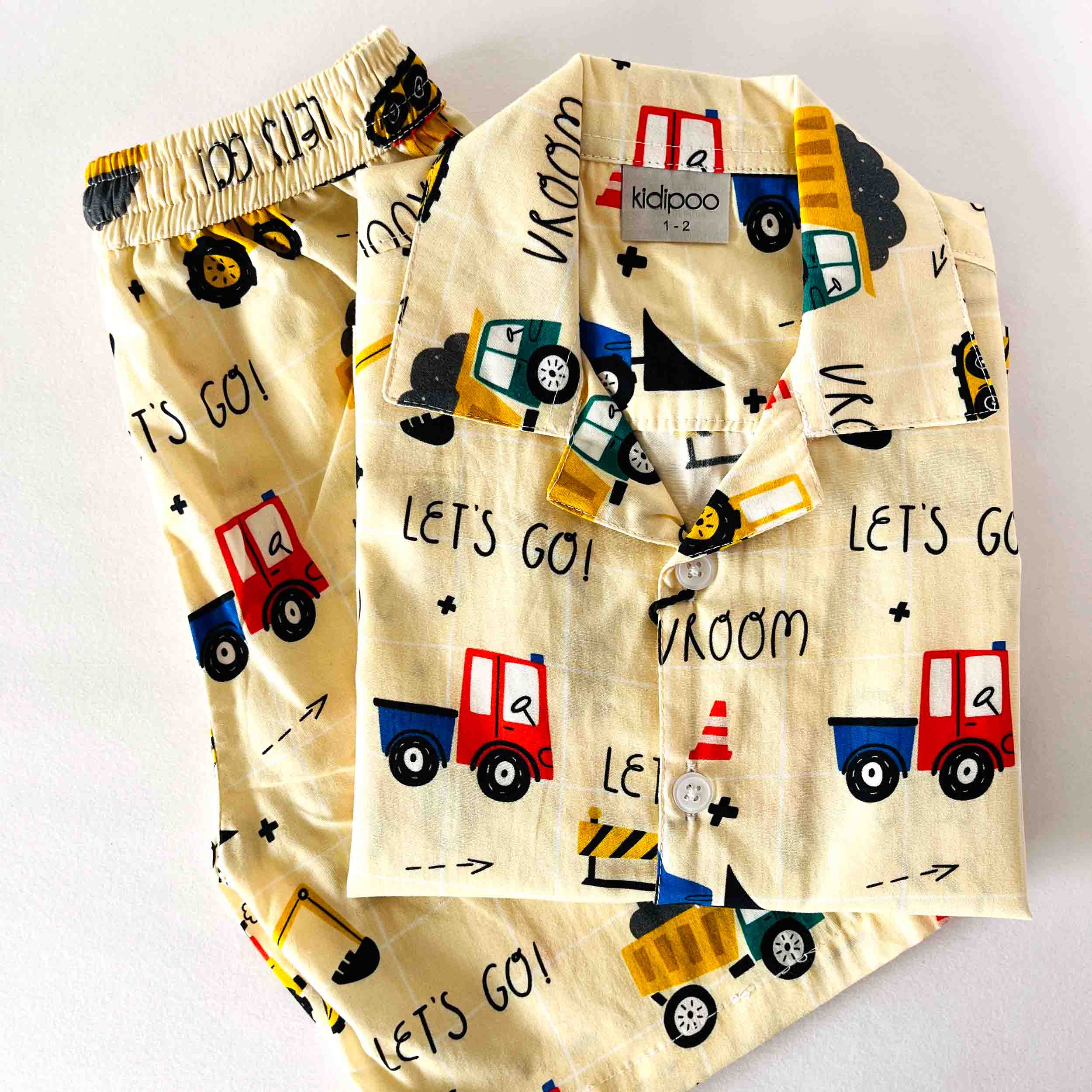 Children's pajama set with truck pattern on a white background