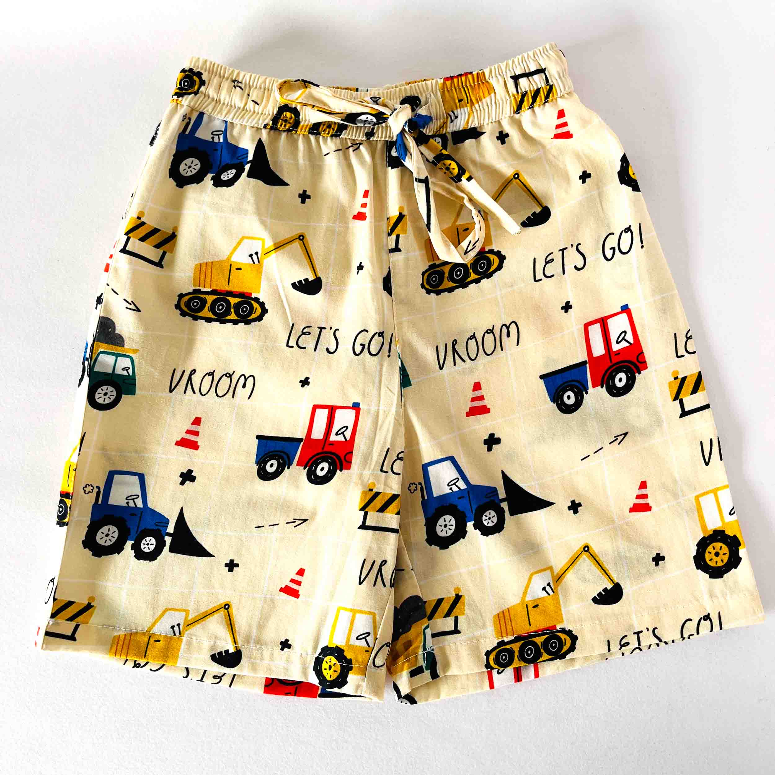 Children's shorts with construction vehicle pattern on a white background