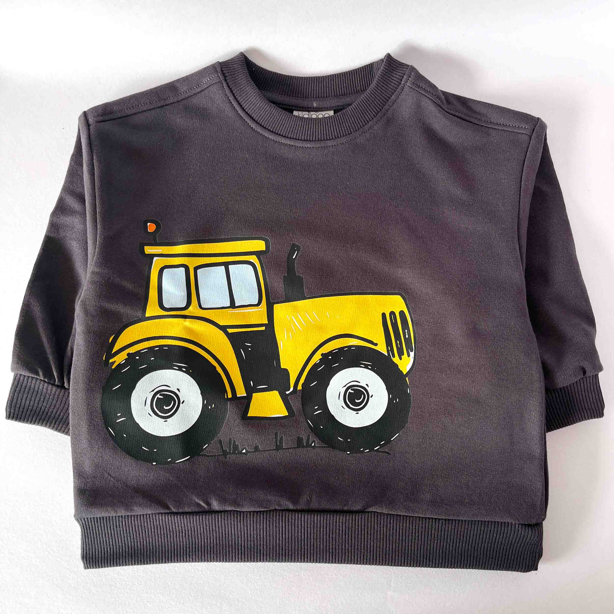 Children's sweatshirt with a yellow tractor design on a white background
