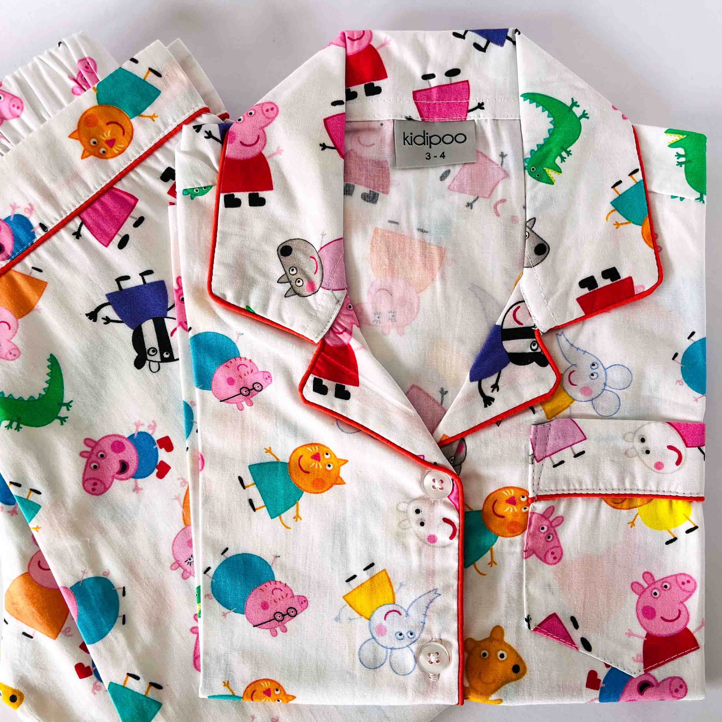 Children's pajama set with peppa pig cartoon character pattern on a white background