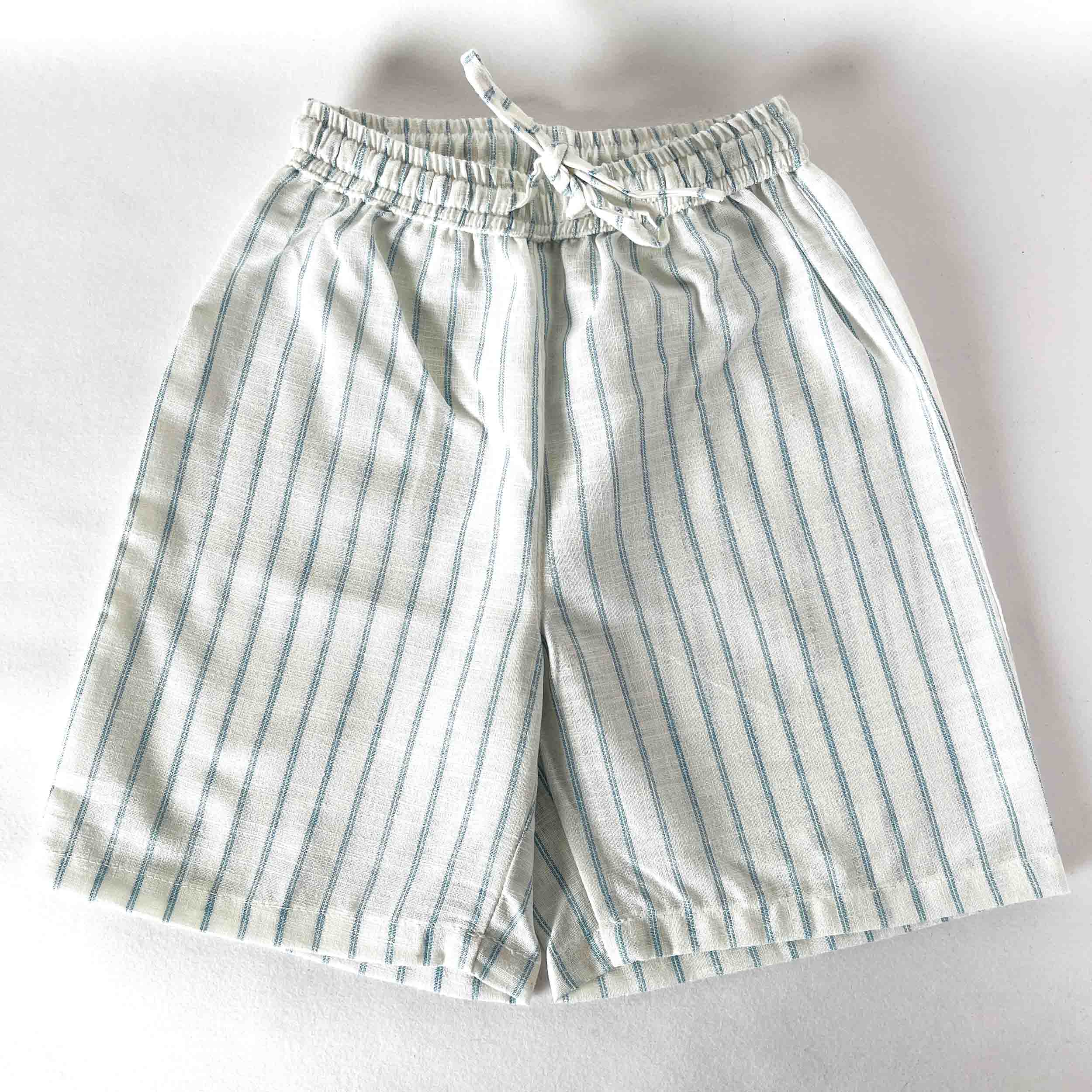 Kids striped shorts with an elastic waistband and drawstring, displayed on a light background