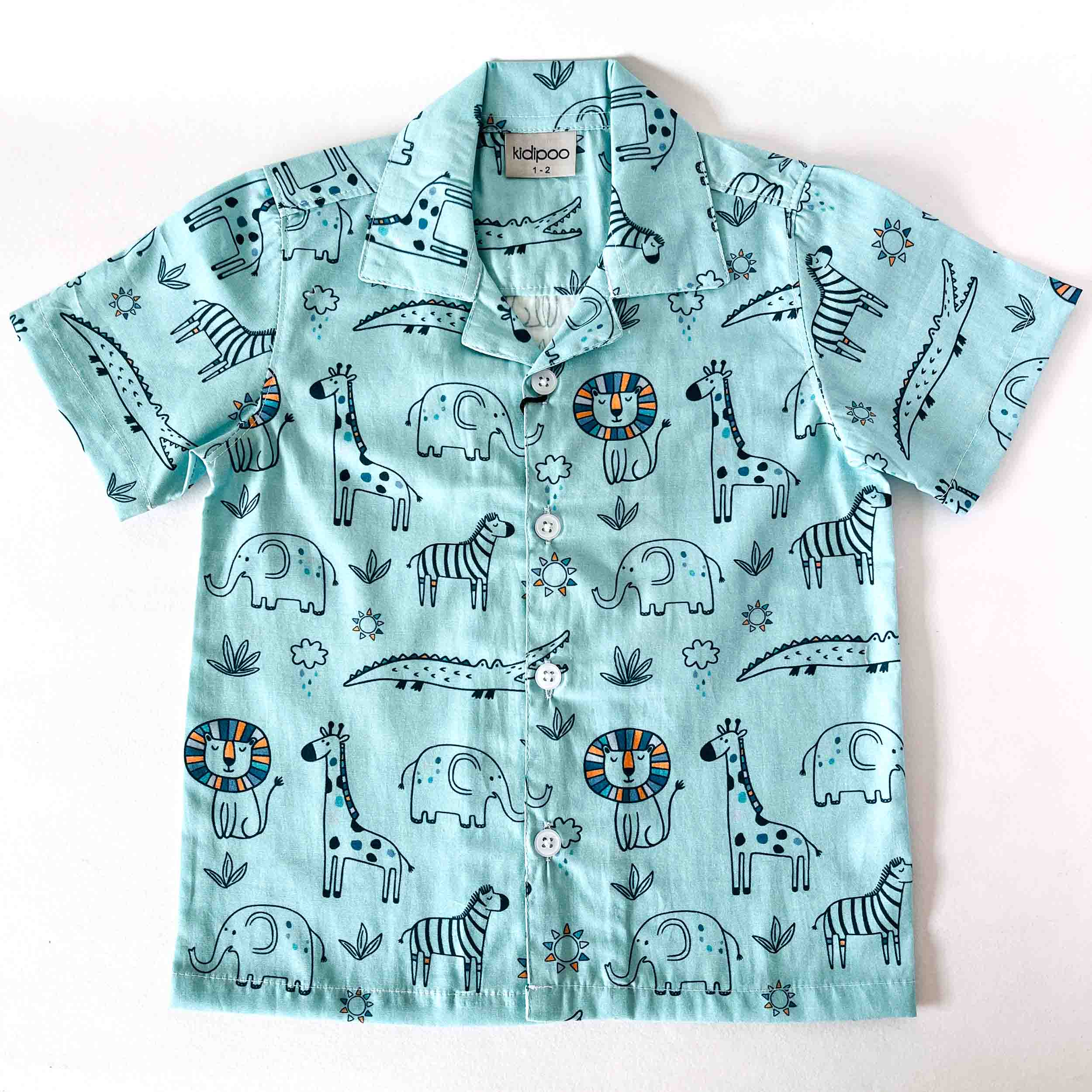 Children's shirt with animal pattern on a light blue background
