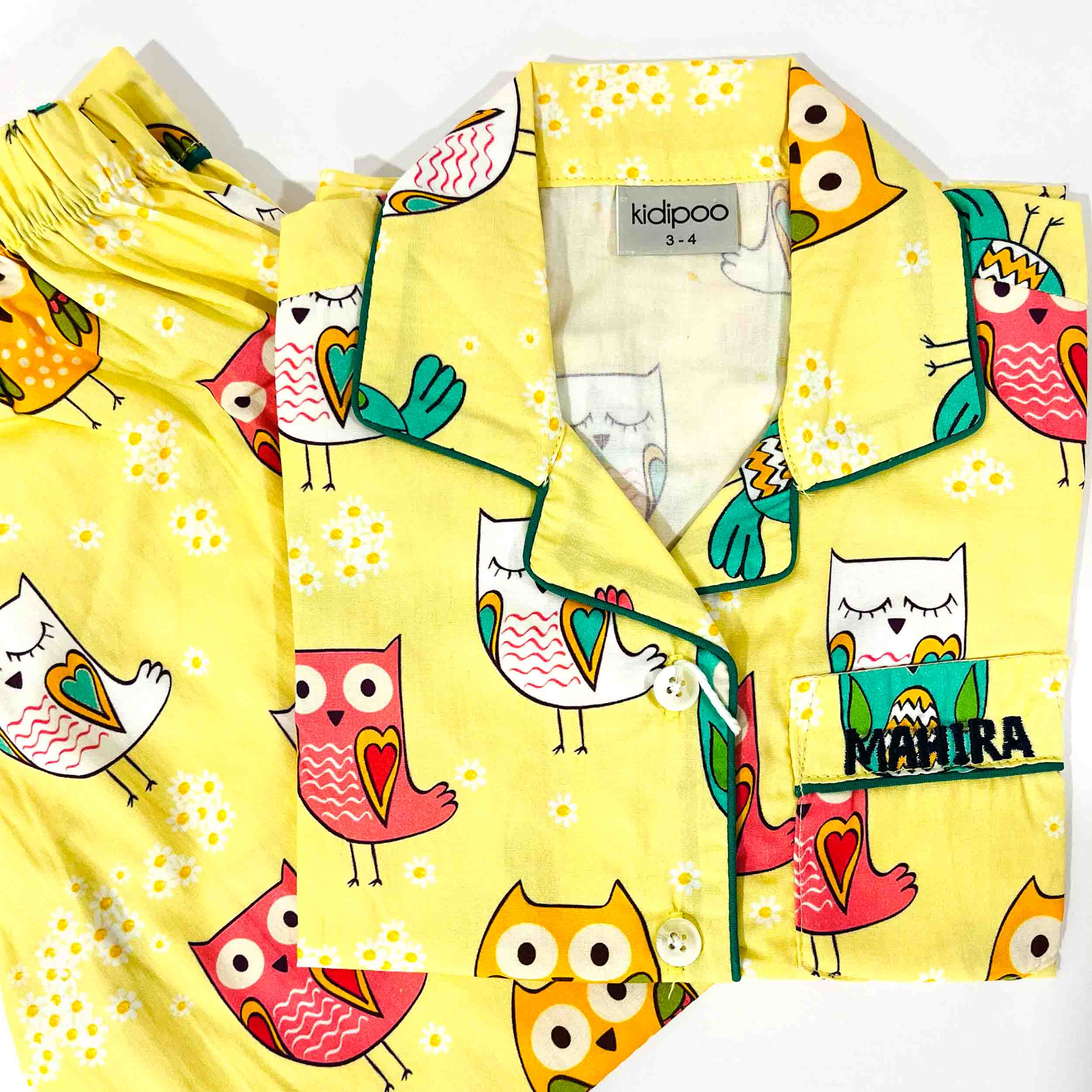 Yellow robe with colorful owl pattern and 'kidipoo' branding