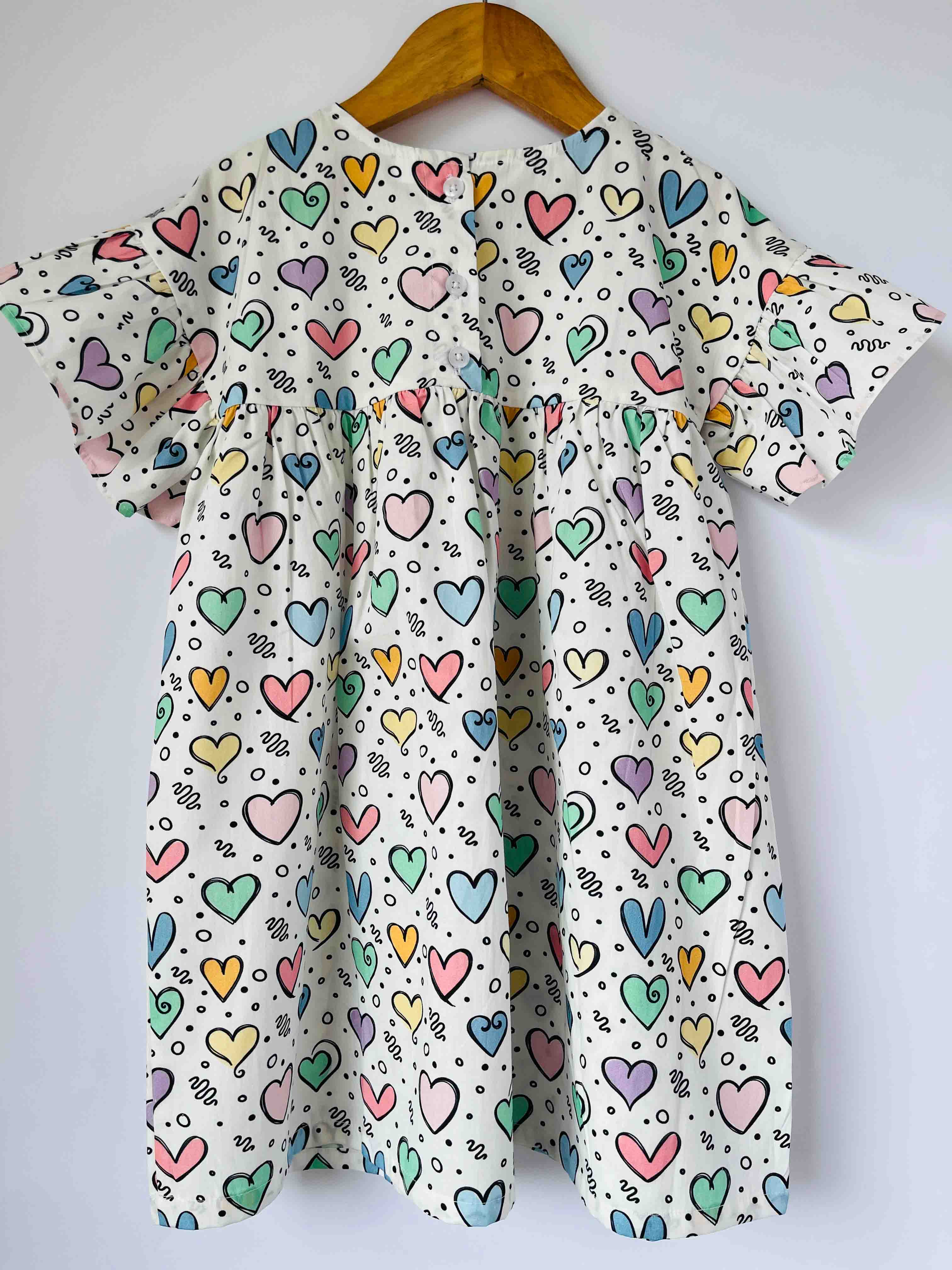 Kids cotton dress with multicolor hearts print and back button closure 